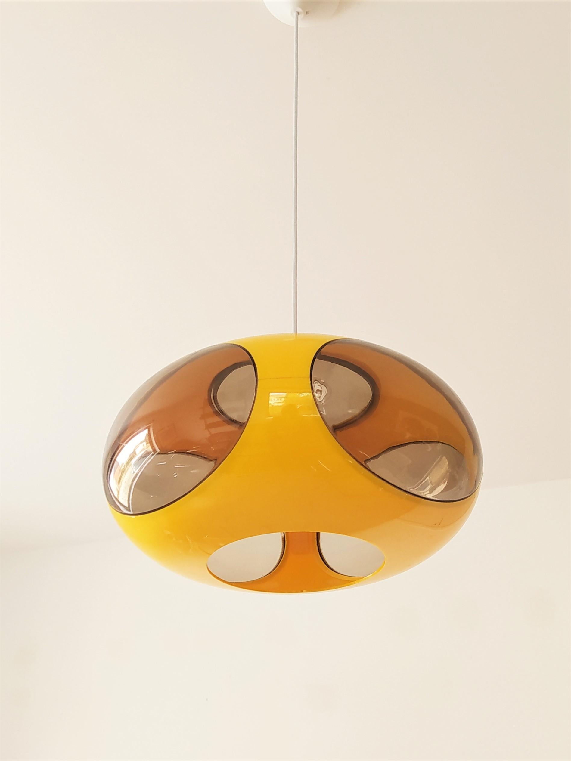 This vintage 70s UFO lamp is space age design at its best! The lamp is made of plastic with bright yellow and fumed transparent surfaces. Please send a message if you want to check if there are other colours available. The lamp, many times referred