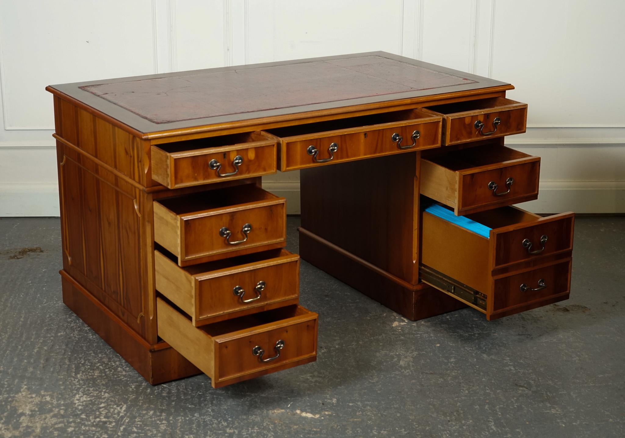 
We are delighted to offer for sale this Vintage Yew Twin Pedestal Desk With Burgundy Leather Top.

This vintage Yew twin pedestal desk with a burgundy leather top exudes an aura of classic refinement and traditional charm. Crafted from beautiful