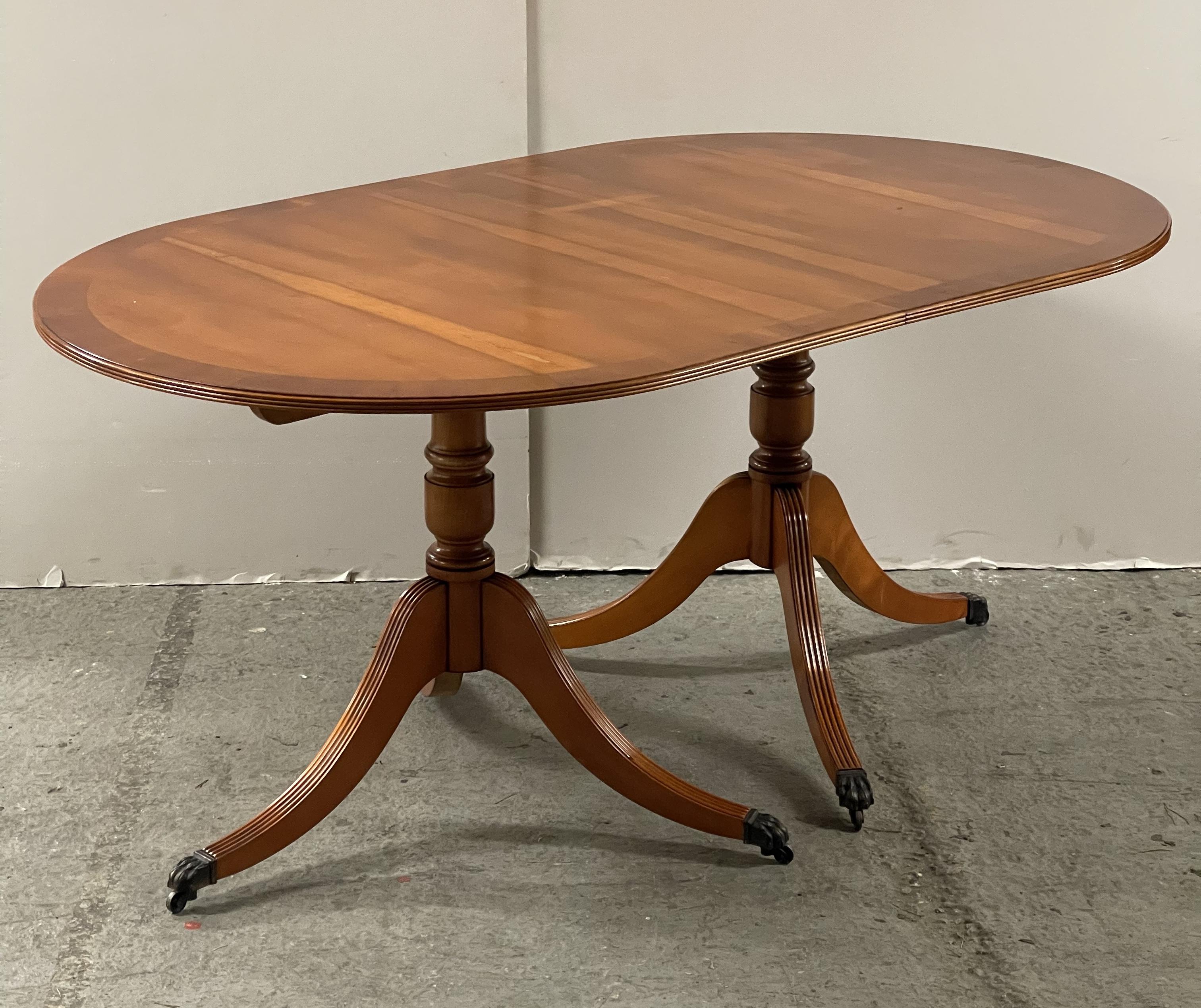 Here we have for sale this lovely vintage yew wood twin pedestal extending dining table seats 6-8 people.

This solid dining table can extend to comfortably seat 8 people standing on twin pedestals with claw feet detailing. It is in good condition