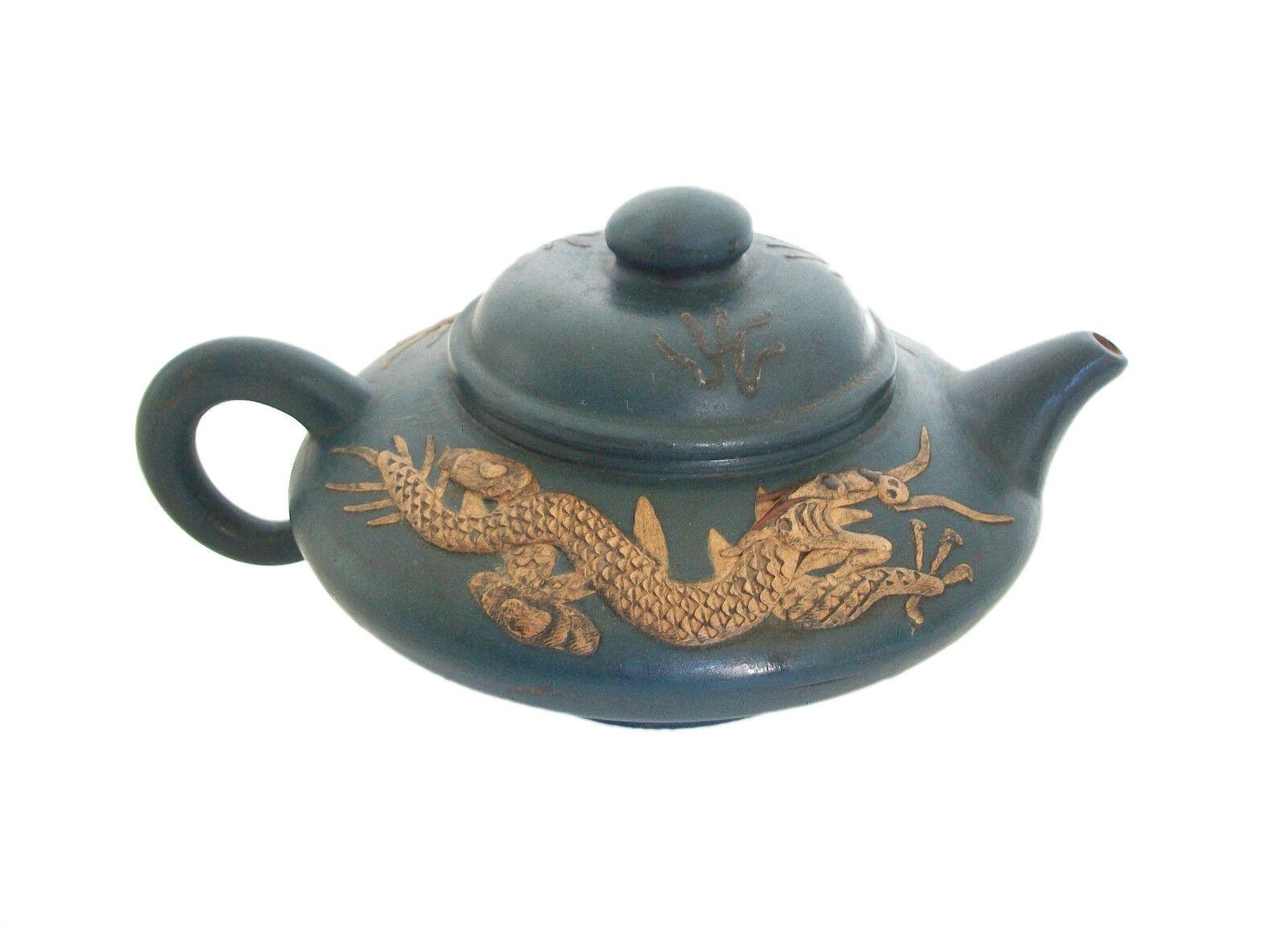 Vintage Yixing Zisha teapot - rare indigo glaze - finely carved dragons to each side - carved flames in relief to the lid - black stain to the hand carved areas with highlights in red - signed on the base and to the interior of the lid (unidentified