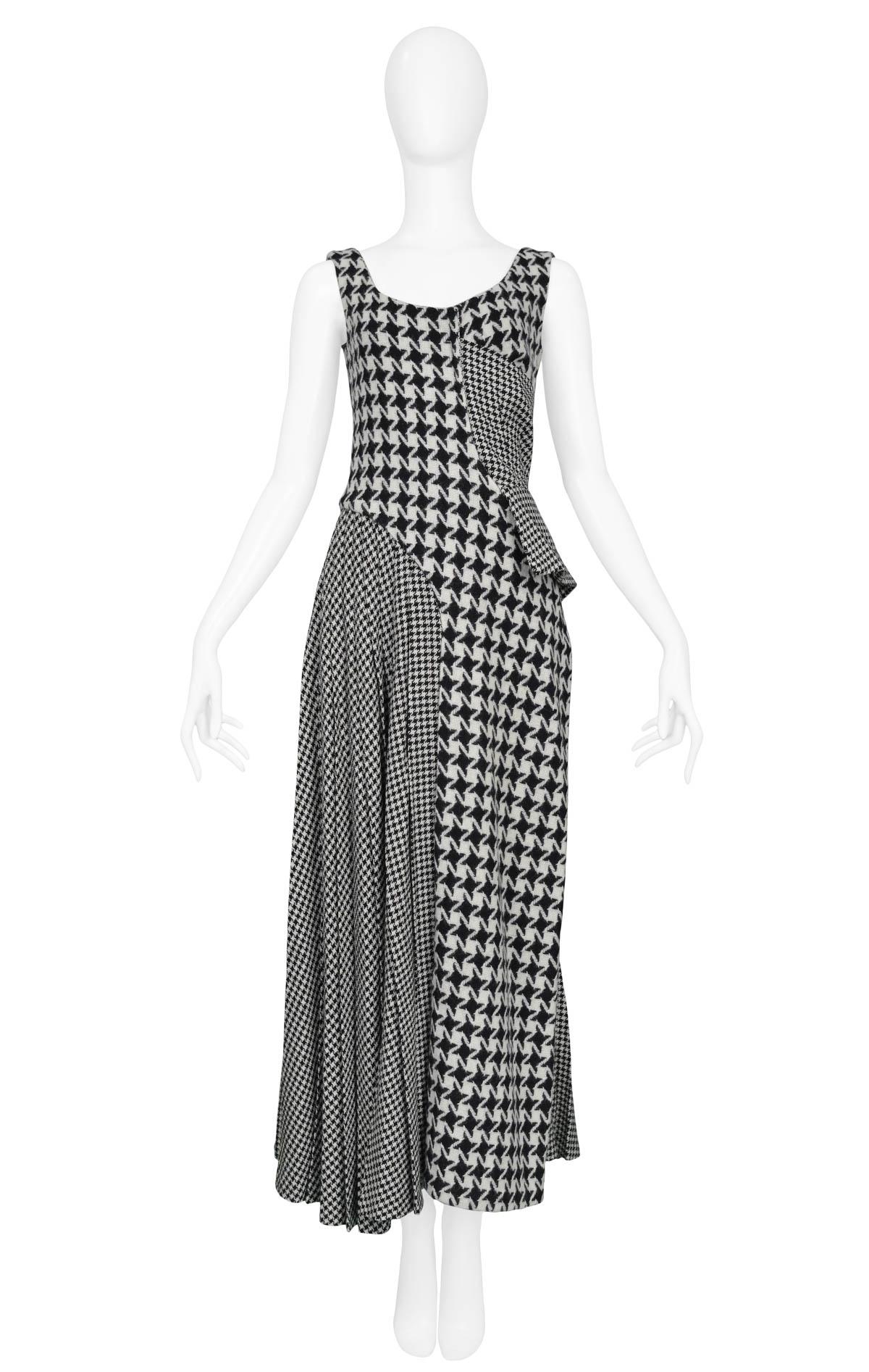 Vintage Yohji Yamamoto sleeveless scoop neck dress featuring various sizes of houndstooth in both navy and black color ways, a side peplum and draped pleating at the right hip and back.

Size: 2 (Medium)

Excellent Condition 