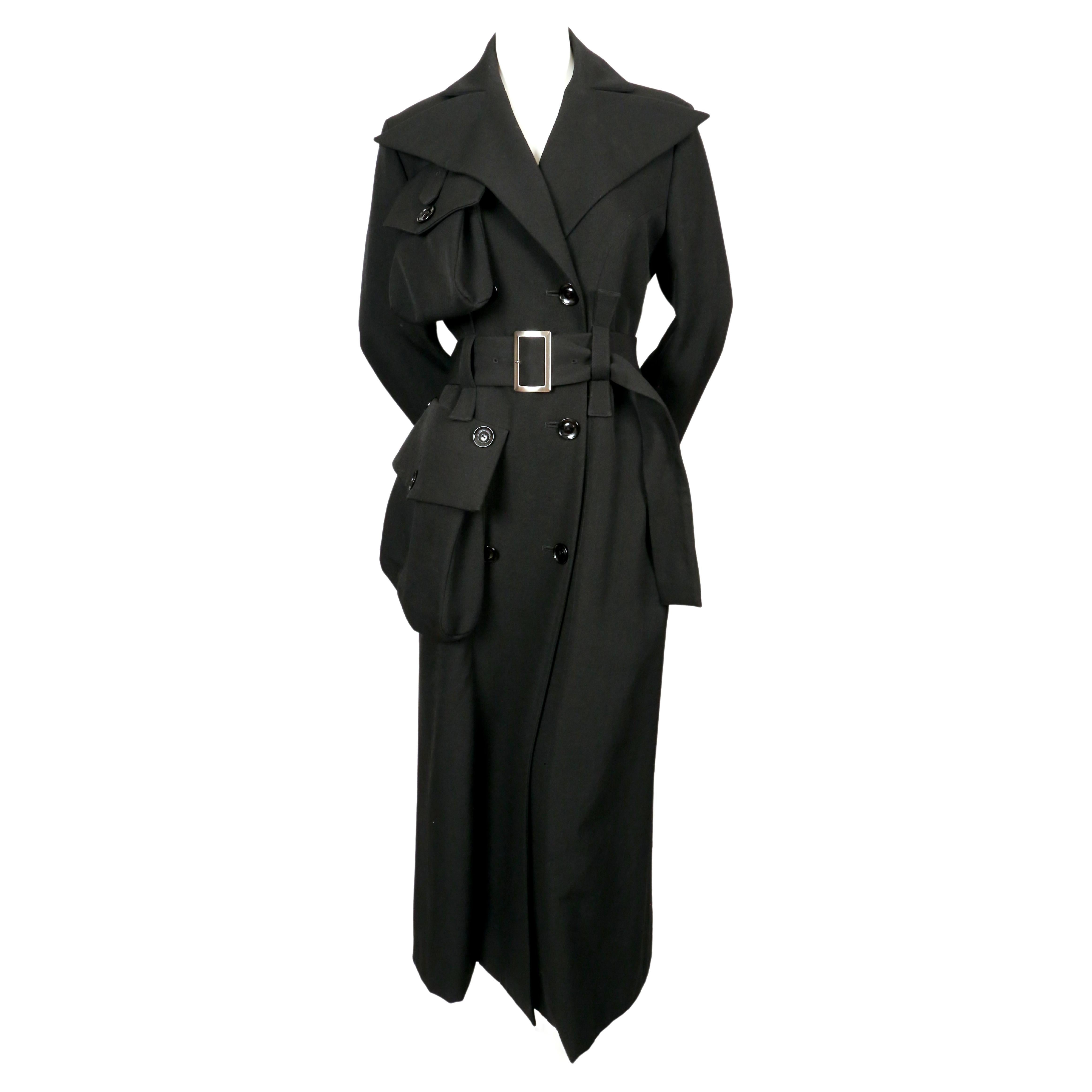 Very unique, long black wool coat with three-dimension sack 'pocket' details designed by Yohji Yamamoto exactly as seen on the fall 2004 runway. Coat has a really great silhouette with a very flattering fit. It is a very rare find. Coat is labeled a