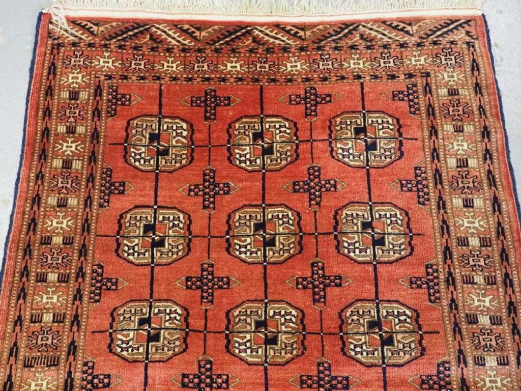 Vintage Yomut Turkmen rug of small size and traditional design
Circa 1930

The rug has three rows of six Turkmen guls on a soft faded red field, the border design and elems frame the rug well The rug retails its short kilim end finishes and ivory