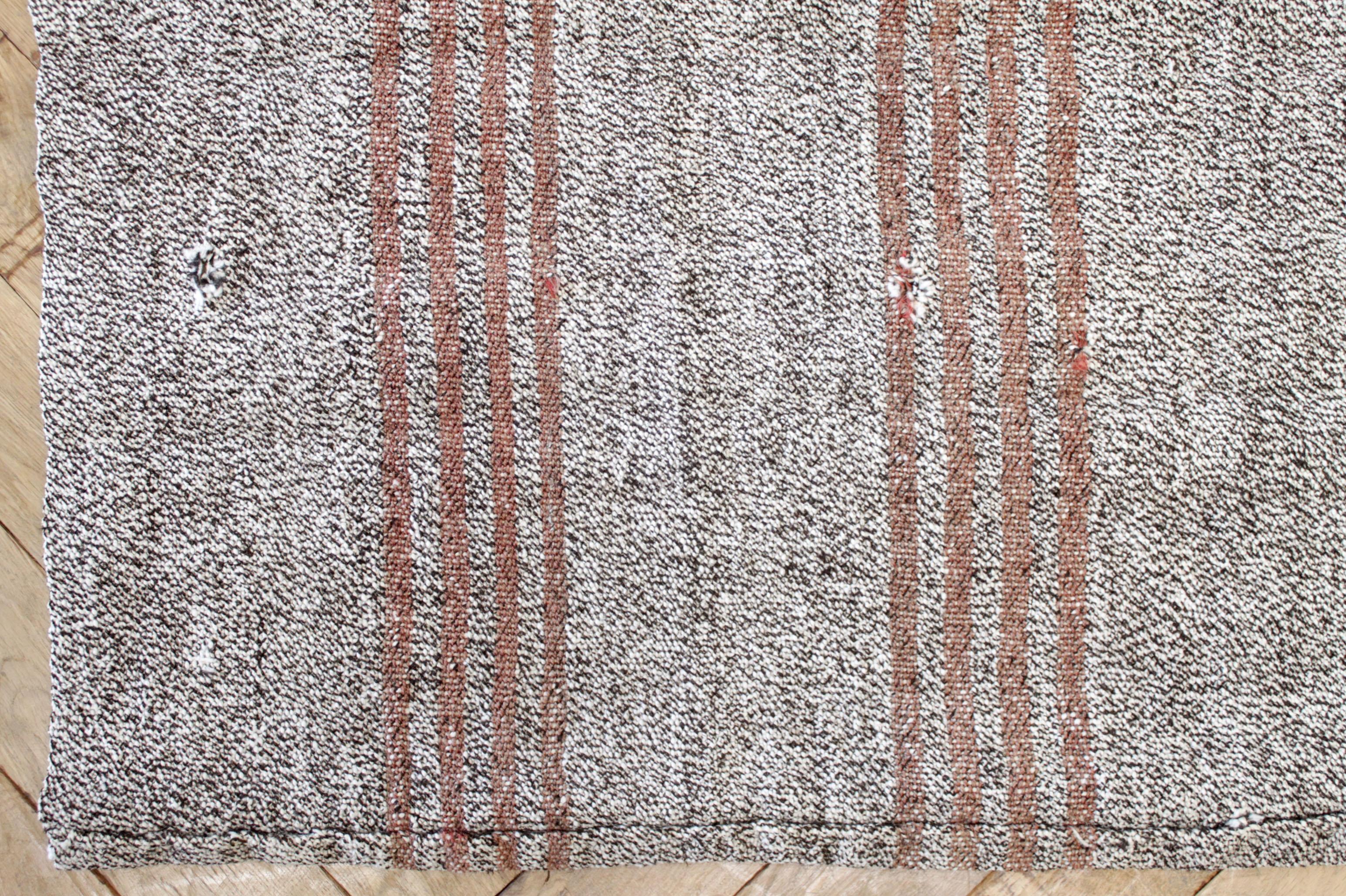 York rug
Vintage Turkish rug in grayish tone background with subtle brown tones, and light coral colored stripes.

Flat-weave, wool and goat hair, make these extremely durable with great use for high traffic areas. This item has been cleaned, and is