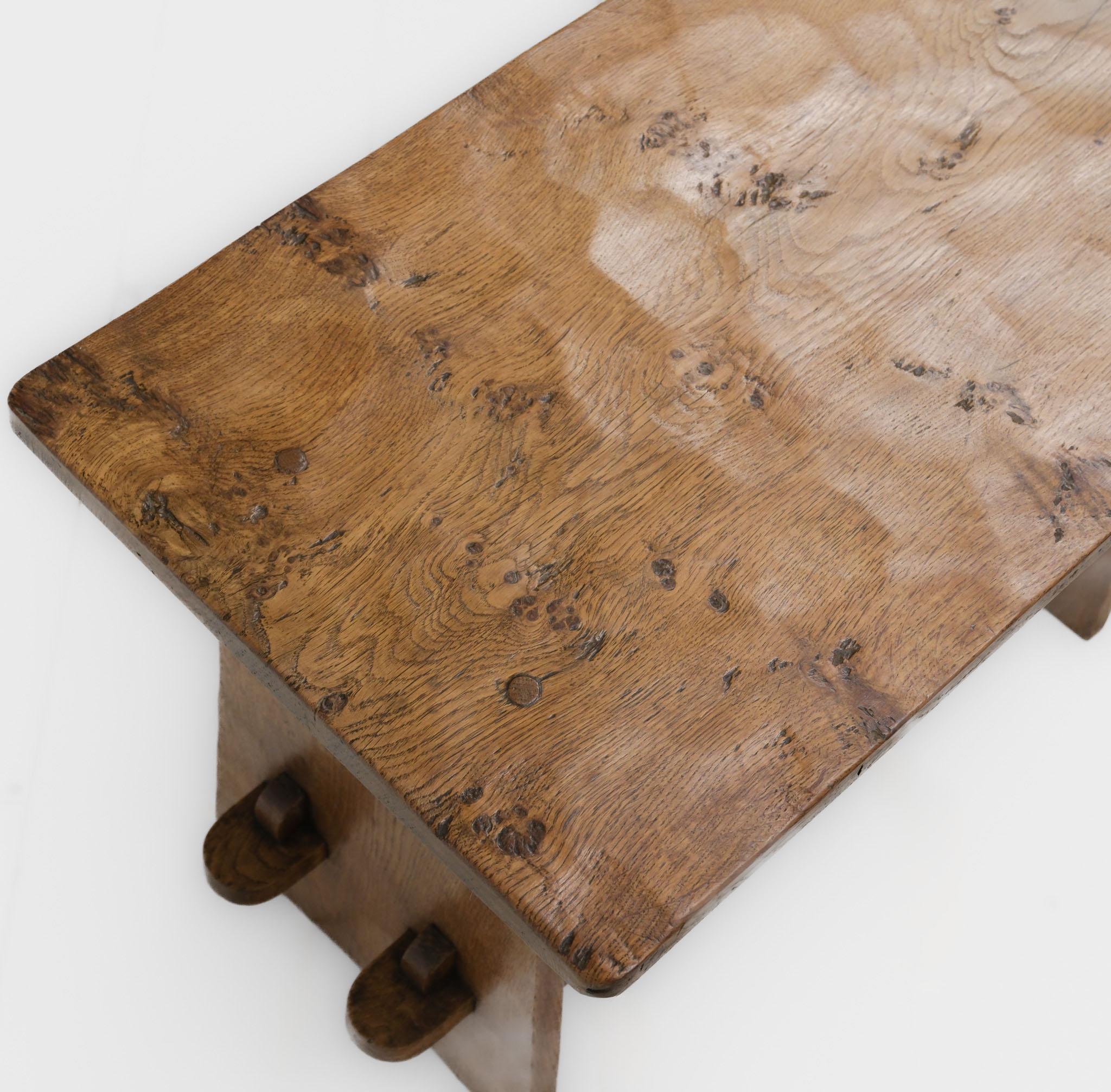 Vintage adzed oak coffee table by Thomas 'Gnomeman' Whittaker of Littlebeck (1910-1991)  Circa 1960.

Thomas Whittaker made the gnome his craft signature, chosen from a Nordic legend which states that whenever an acorn germinates, a gnome is born as