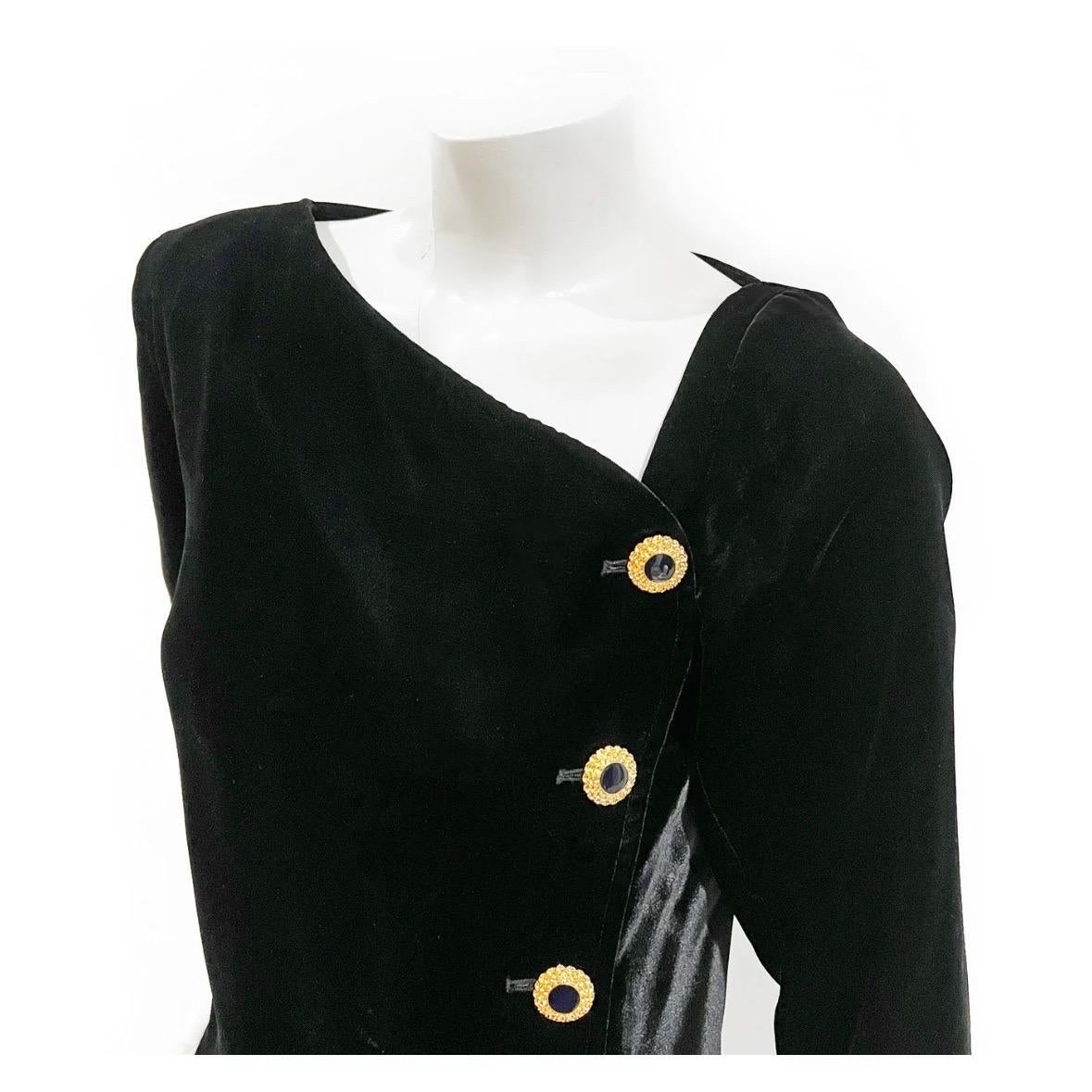 Vintage Asymmetrical Velvet Button Front Dress by Saint Laurent Rive Gauche
1980's
Made in France
Black velvet 
Long sleeves
Asymmetrical neck line 
Single (right) shoulder pad
Decorative (and functioning) gold-metal buttons down front
Corresponding