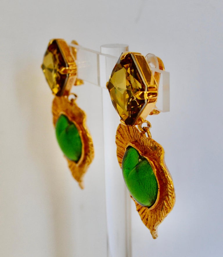 Clip earrings earrings made in the 80s.. Chartreuse green poured glass heart in the center, one of Yves Saint Laurent favorite color. Top is a Swarovski topaz green crystal. Gilded brass dipped in 18-carat gold. Signature on the back. Excellent