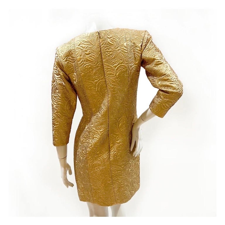 Gold brocade dress by Yves Saint Laurent Rive Gauche 
Made in France
Fall 1991 RTW
Gold brocade pattern throughout
Knee-length  
Quarter-length sleeves 
Back zipper w/ hook and eye closure 
Silk blend shell with silk lining
Condition: Excellent