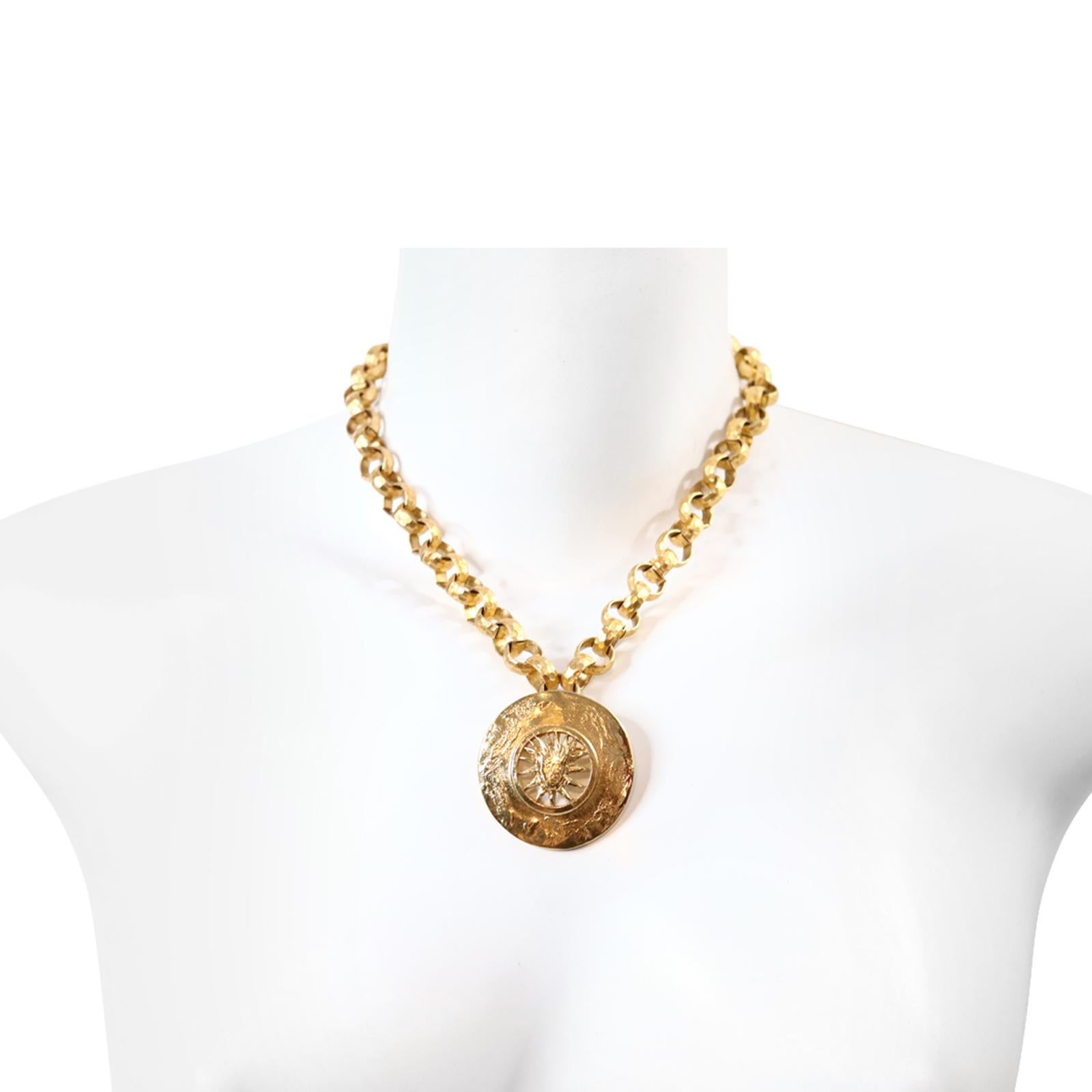Vintage YSL  Gold Tone Sun Brooch/Pendant on Rollo Chain Circa 1980s.  The Sun Piece is Signed YSL. The Necklace is not.  The Necklace is a hammered Rollo chain and looks great on the pendant. Will always be in style. 