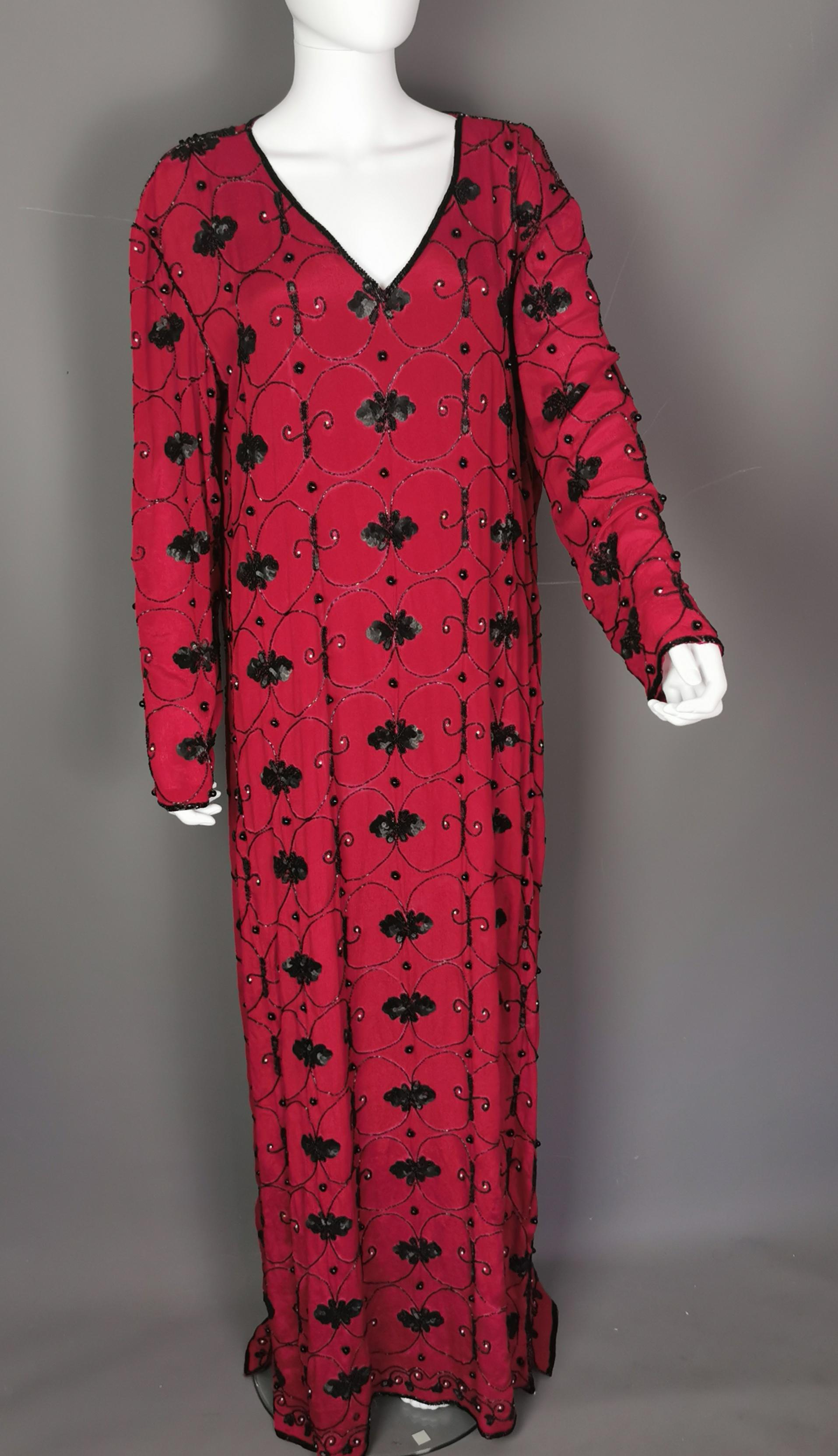 A truly magnificent vintage YSL Rive Gauche beaded sequin maxi dress.

A rare find, this dress has everything going and is YSL at its finest.

This is a long sleeved dress with a long flowing skirt, wider sleeves and a relaxed drapey silhouette,