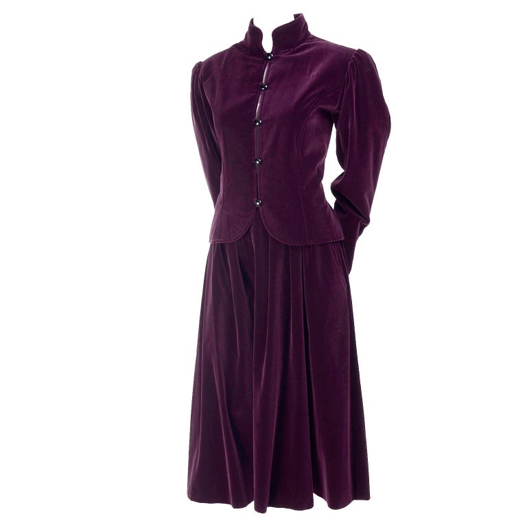 This Russian inspired  vintage deep red velvet skirt and jacket ensemble from Yves Saint Laurent is so lovely.  The 2 piece suit includes a Mandarin collar jacket and a softly pleated skirt.  The jacket has YSL''s classic round buttons up the front