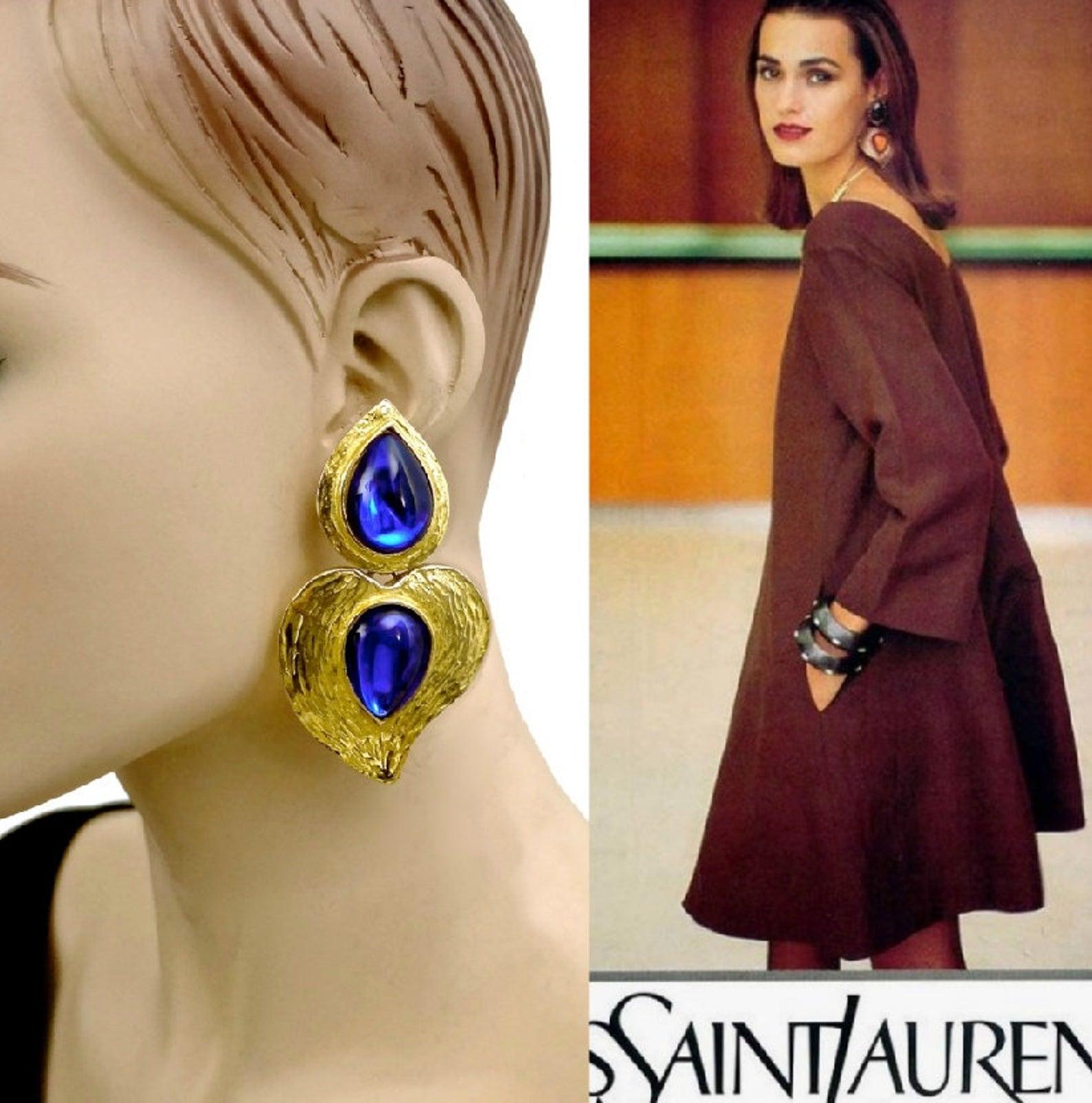 Vintage YSL Yves Saint Laurent by Robert Goossens Stylized Heart Blue Cabochon Drop Earrings

Measurements:
Height: 3.22 inches (8.2 cm)
Width: 1.81 inches (4.6 cm)
Weight per Earring: 31 grams

Features:
- 100% Authentic YVES SAINT LAURENT by
