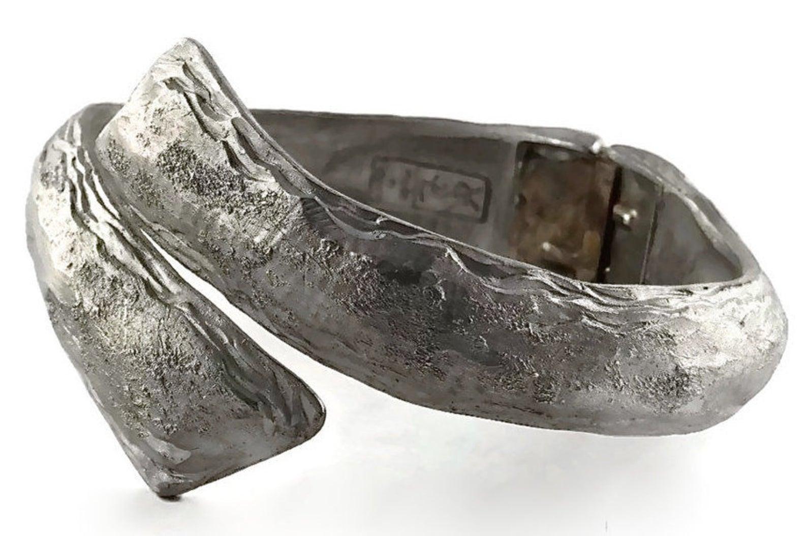Vintage YSL Yves Saint Laurent Coil Wrap Textured Cuff Bracelet

Measurements:
Centre Height: 1 3/8 inches (3.49 cm)
Inside Circumference: 7 inches (17.78 cm)

Features:
- 100% Authentic YVES SAINT LAURENT.
- Rigid coil wrap cuff bracelt.
- Textured