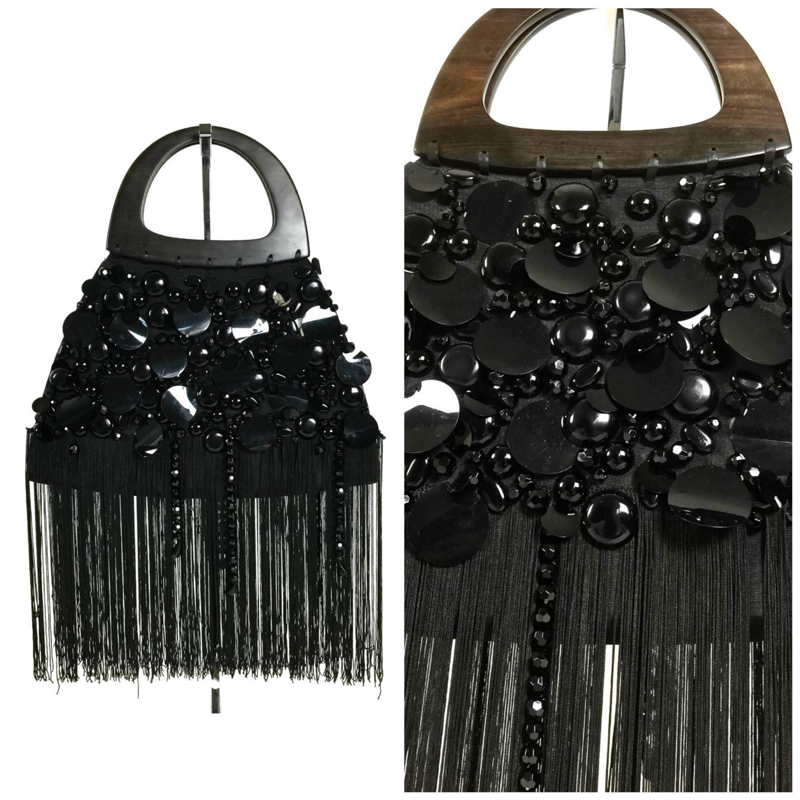 Vintage YSL Yves Saint Laurent Disc Beaded Fringe Wood Top Handle Hand Bag

Measurements:
Total Height: 24 inches (60.96 cm) handle and fringes included
Width: 14 6/8 inches (37.46 cm)
Depth: 2 2/8 inches (5.71 cm)

Features:
- 100% Authentic YVES
