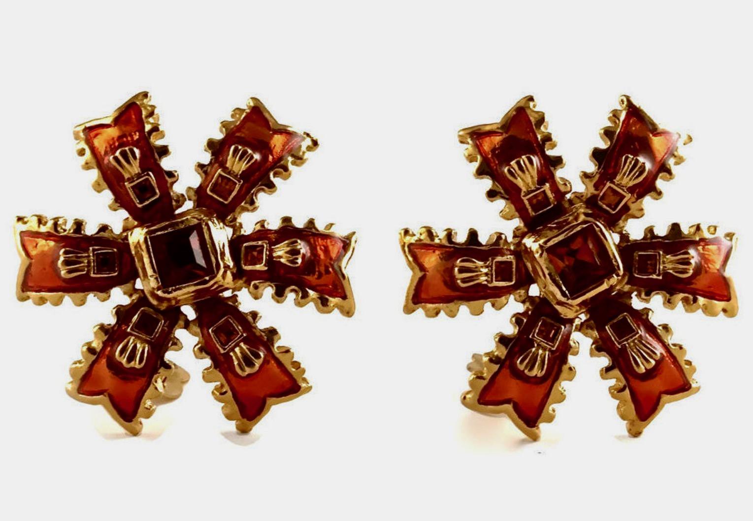 Vintage YSL Yves Saint Laurent Enamel Ribbon Rhinestone Earrings

Measurements:
Height: 1 6/8 inches (4.44 cm)
Width: 1 6/8 inches (4.44 cm)

Features:
- 100% Authentic YVES SAINT LAURENT.
- Orange motif enamel ribbon pattern with rhinestones