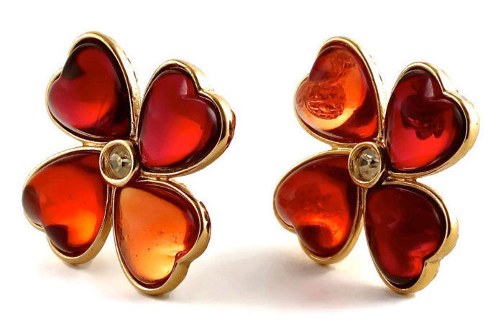 Vintage YSL Yves Saint Laurent Heart Clover Resin Earrings

Measurements:
Height: 1 4/8 inches (3.81 cm)
Width: 1 4/8 inches (3.81 cm)

Features:
- 100% Authentic YVES SAINT LAURENT.
- Plump heart shape forming a 4 leaf clover.
- Ruby and amber