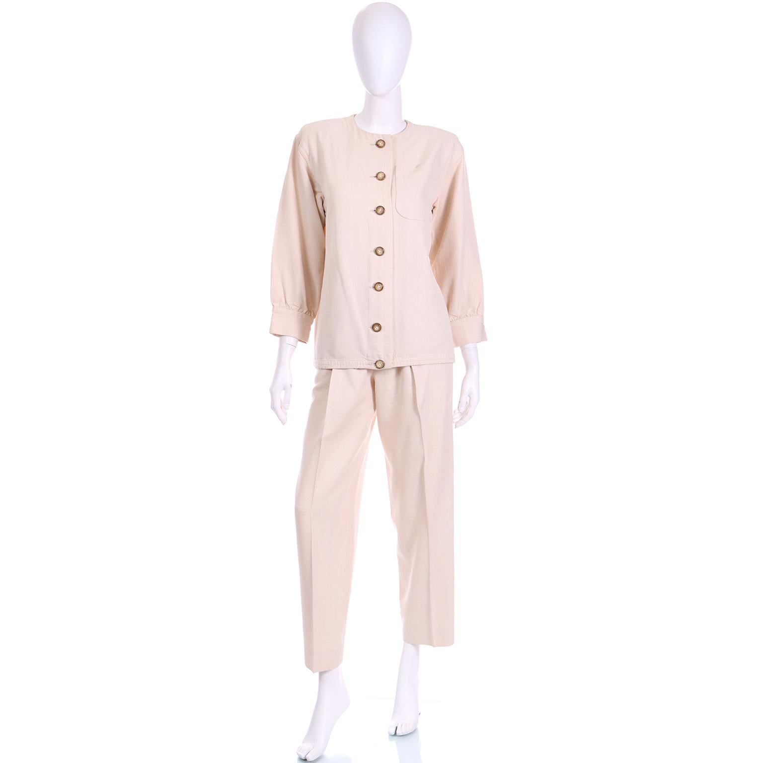 This vintage Yves Saint Laurent neutral pantsuit from the late 1970s or early 1980s exemplifies YSL's enduring commitment to theme elements in his designs. A reinterpretation of the classic safari look, this ensemble comprises a tan jacket with