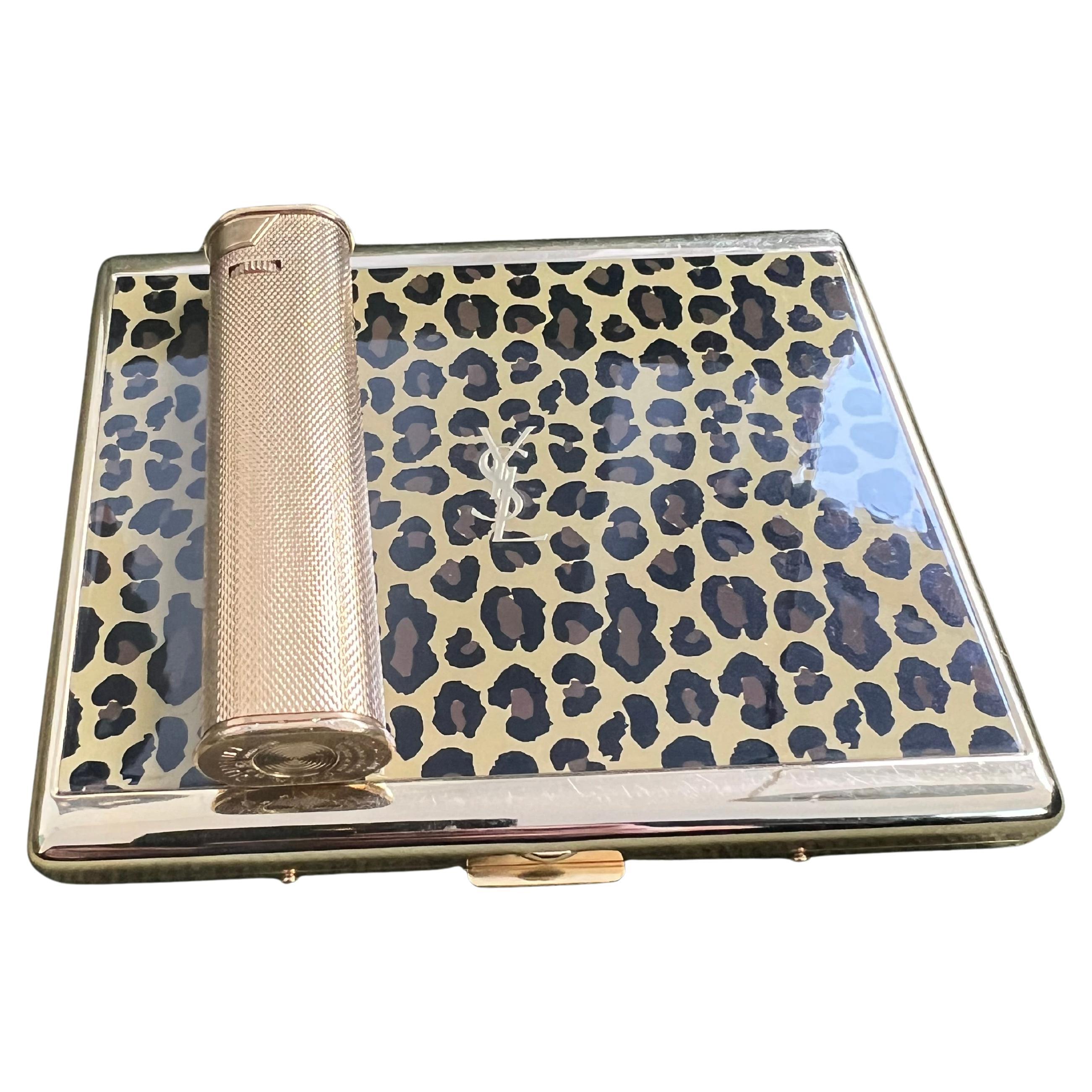 Vintage “YSL” Yves Saint Laurent Retro Cigarette Case & Dunhill Lighter Set 
“Circa 1980”
“YSL” Yves Saint Laurent retro cigarette case and Dunhill lighter 
Logo Cigarette Case Gold Black Blue
The case is in mint condition. It has never been used.