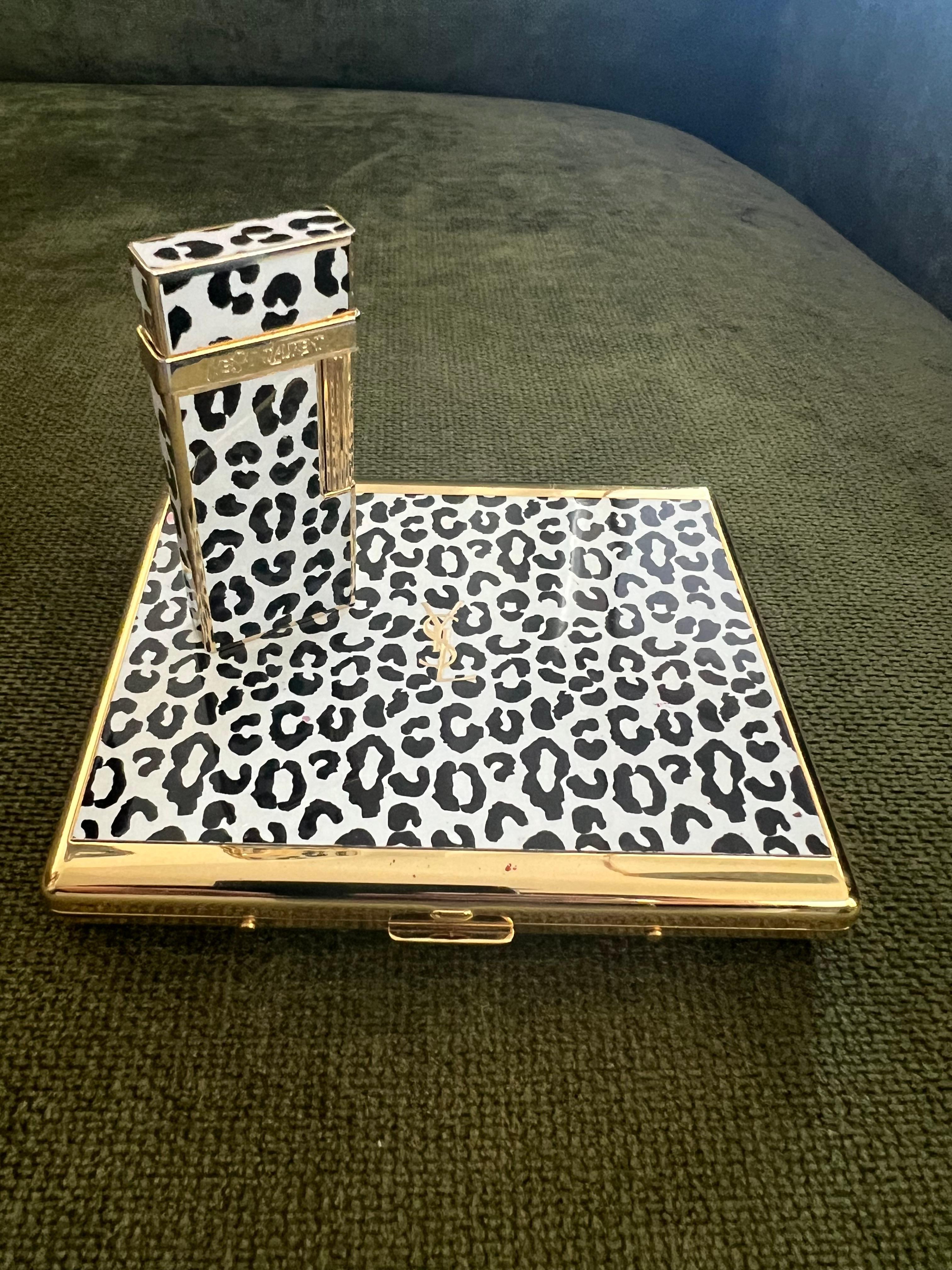 Vintage “YSL” Yves Saint Laurent Retro Cigarette Case & Lighter Set 
“Circa 1980”
“YSL” Yves Saint Laurent retro cigarette case and lighter 
Logo Cigarette Case Gold Black Blue
The case is in mint condition. It has never been used. 
The clasp snaps