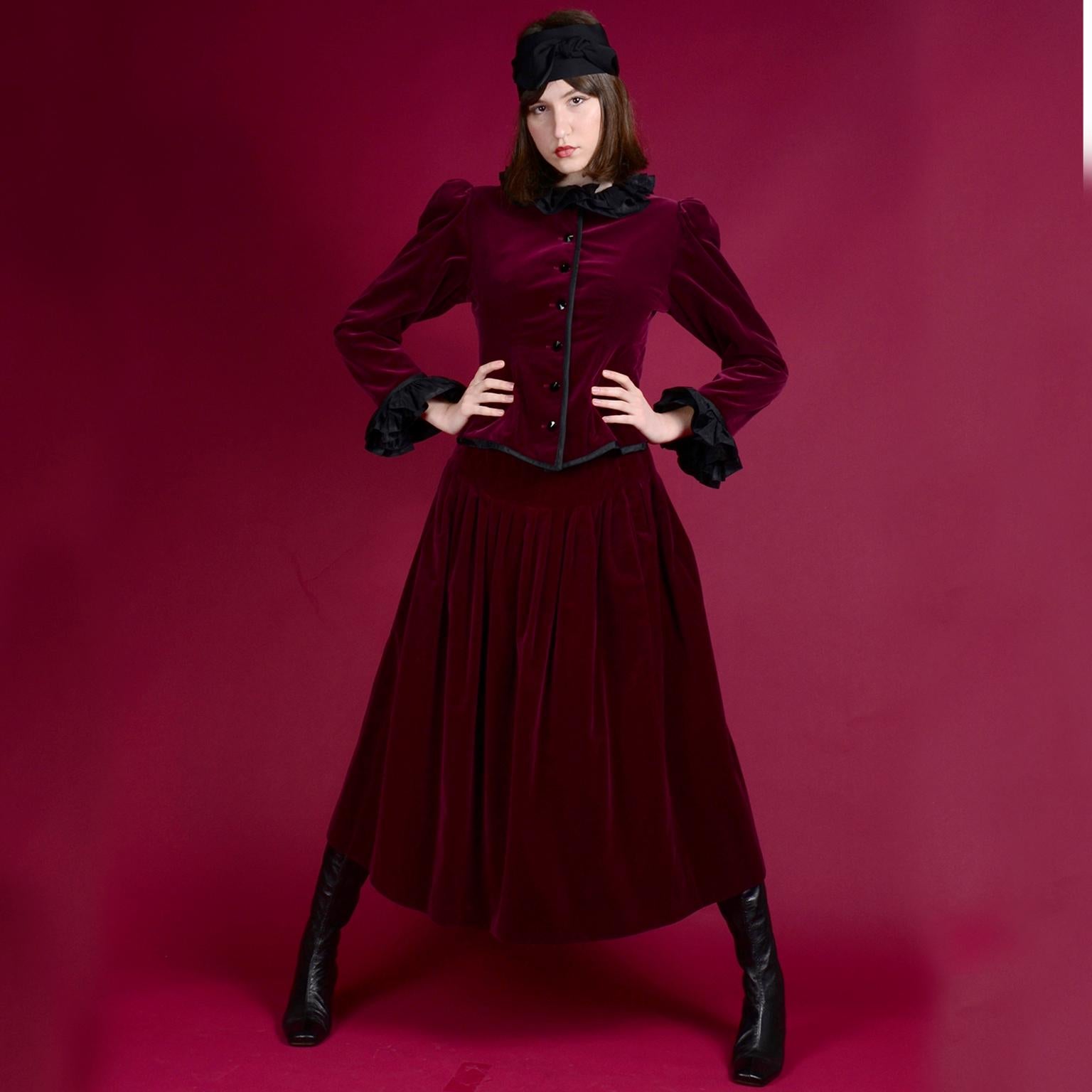 This incredible 2 piece evening ensemble is from Yves Saint Laurent and includes a jacket and a beautiful skirt both in luxe burgundy velvet.  Such a perfect holiday outfit! The fitted jacket is fully lined, and it has ruffled black taffeta on the