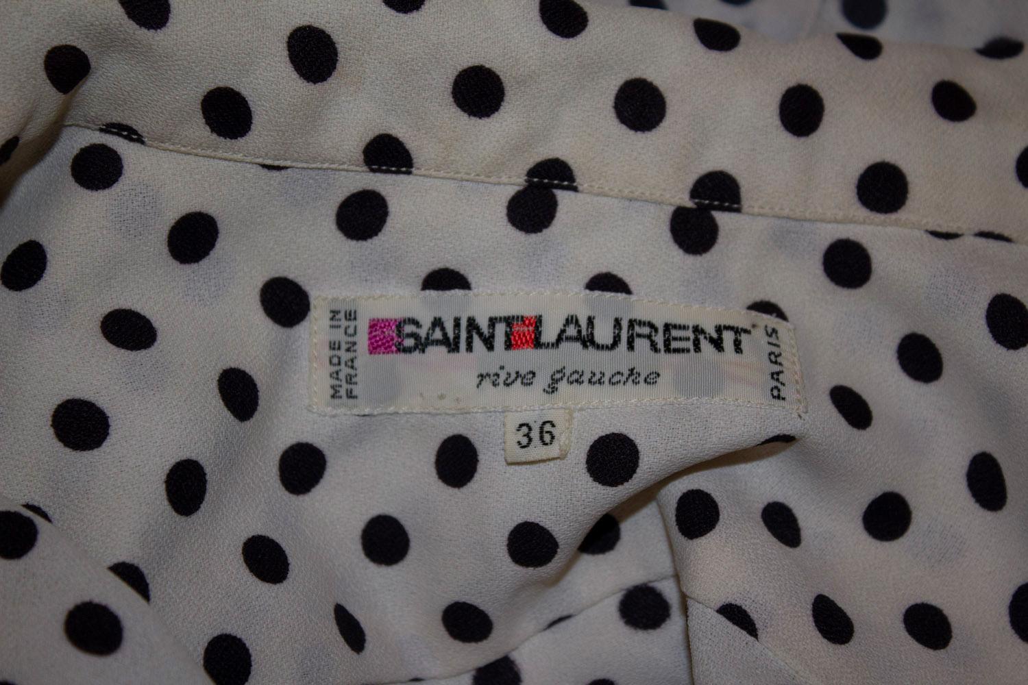 A fun and easy to wear vintage polka dot dress, by Yves Saint Laurent Rive Gauche. The dress has buttons to the waist , sewn in pleats for a flattering line and a side zip opening.
Size 36, Made in France Bust 36'', length 46''