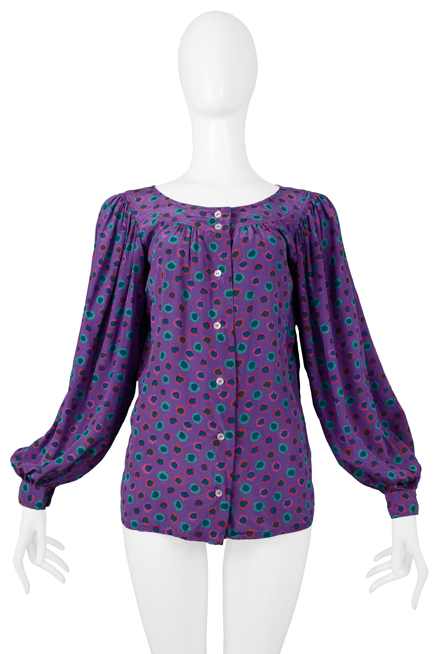 Vintage Yves Saint Laurent purple silk peasant blouse featuring a pink & green floral print, button front closure and blouson cuffed sleeves.

Condition: Excellent Condition

Size: 40