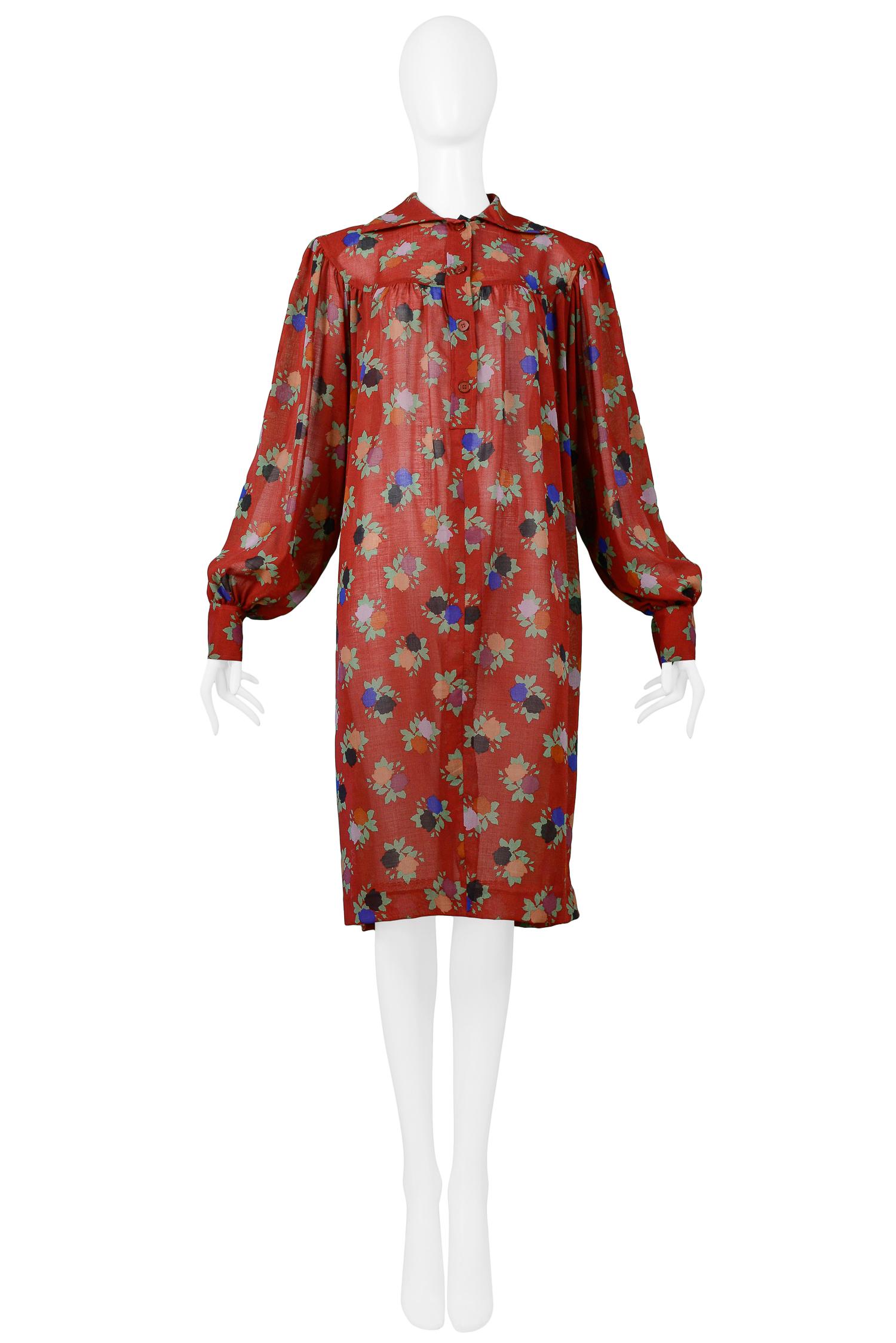 Resurrection Vintage is excited to offer a vintage Yves Saint Laurent burgundy crepe collared smock dress featuring a multi-color painted floral print, blouson sleeves with button cuffs and front button closure.

Yves Saint Laurent
Size