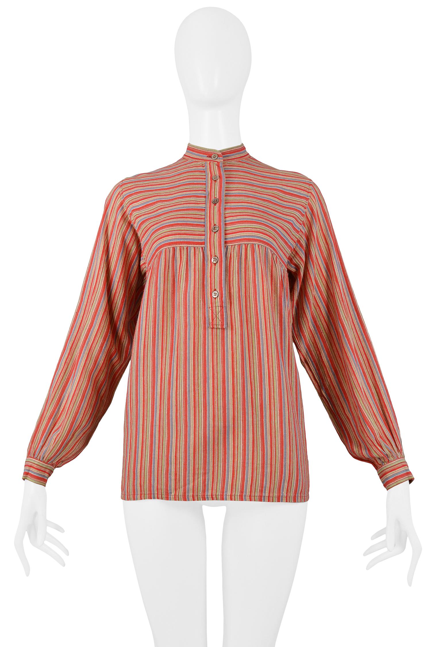 Vintage Yves Saint Laurent red stripe cotton blouse featuring a partial button front, high collar and button cuff detailing at wrists. Circa 1970's.

Excellent Condition.

Size: 36