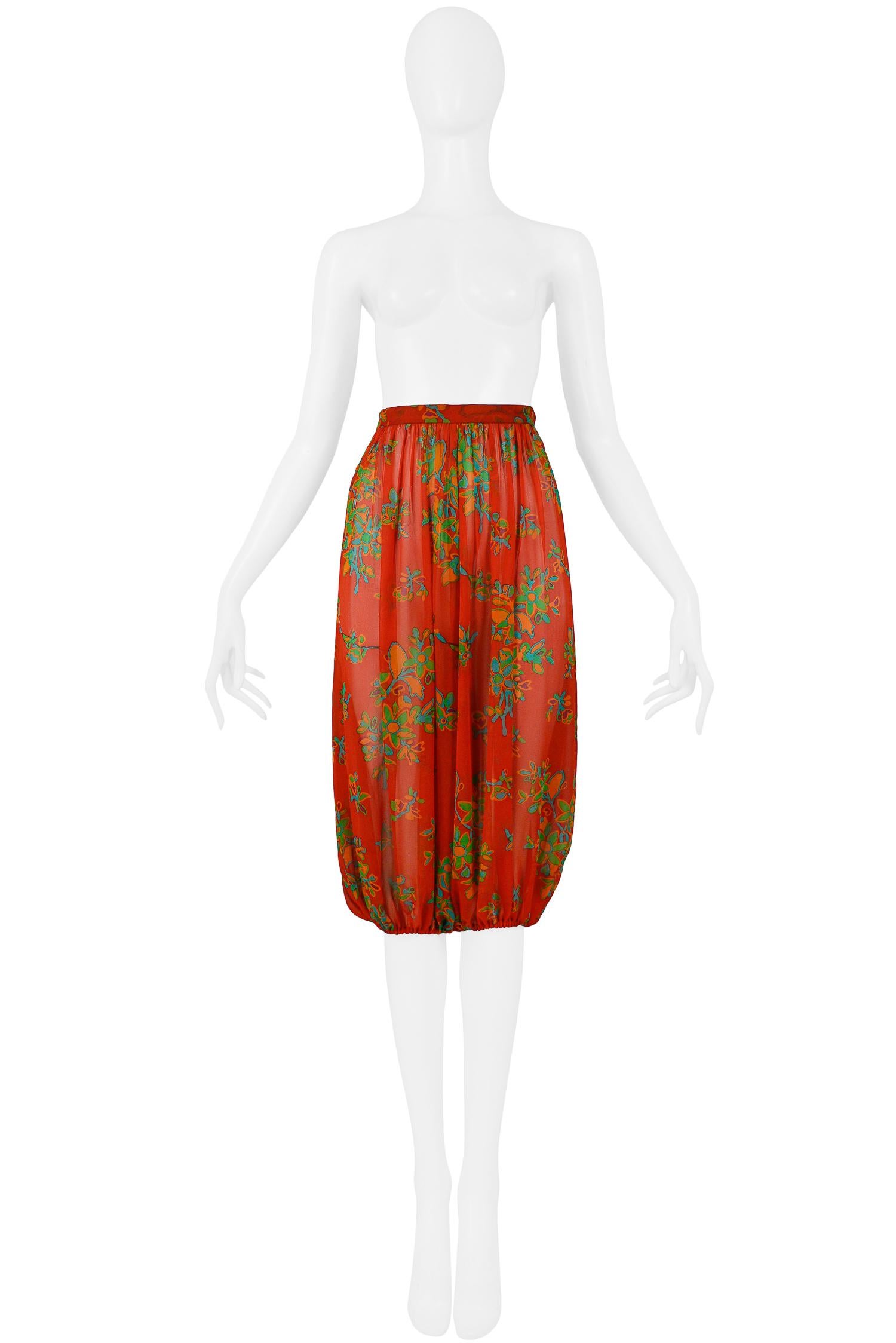 Vintage Yves Saint Laurent red silk chiffon high-waisted harem pants featuring an orange, green, and blue floral print, pleating, elastic cuffs and hook & zipper side closure. From the 1973 Collection.

Excellent Condition.

Size 40

Waist: 25