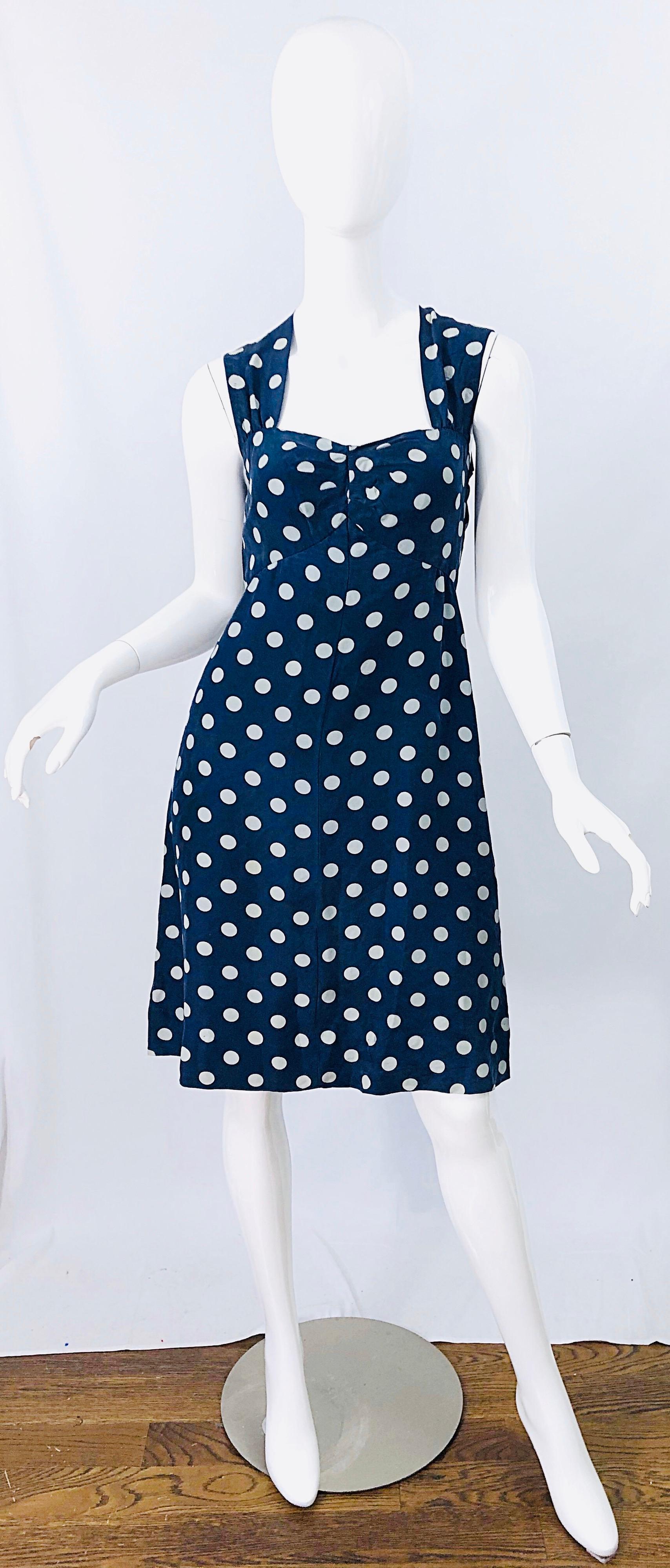 Tres chic 80s YVES SAINT LAURENT YSL Rive Gauche navy blue and white polka dot silk sleeveless dress. Features a tailored bodice with a sweetheart neckline. Flirty skirt offers plenty of room to fit an array of sizes. Hidden zipper up the back. Can