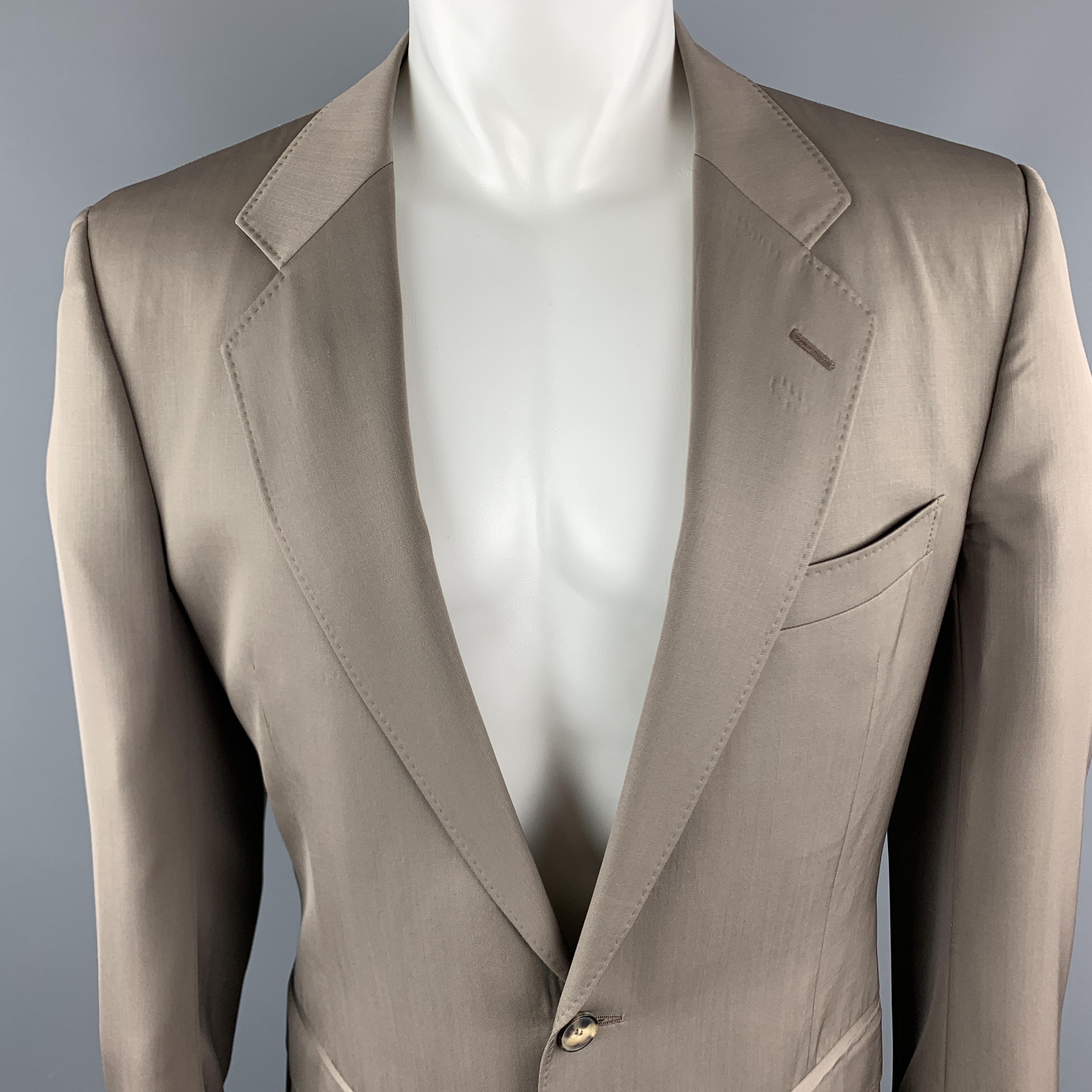 Vintage YVES SAINT LAURENT Rive Gauche suit comes in a taupe wool and includes a single breasted, two button sport coat with a notch lapel and matching flat front trousers. Made in Switzerland. 

Excellent Pre-Owned Condition.
Marked: 52