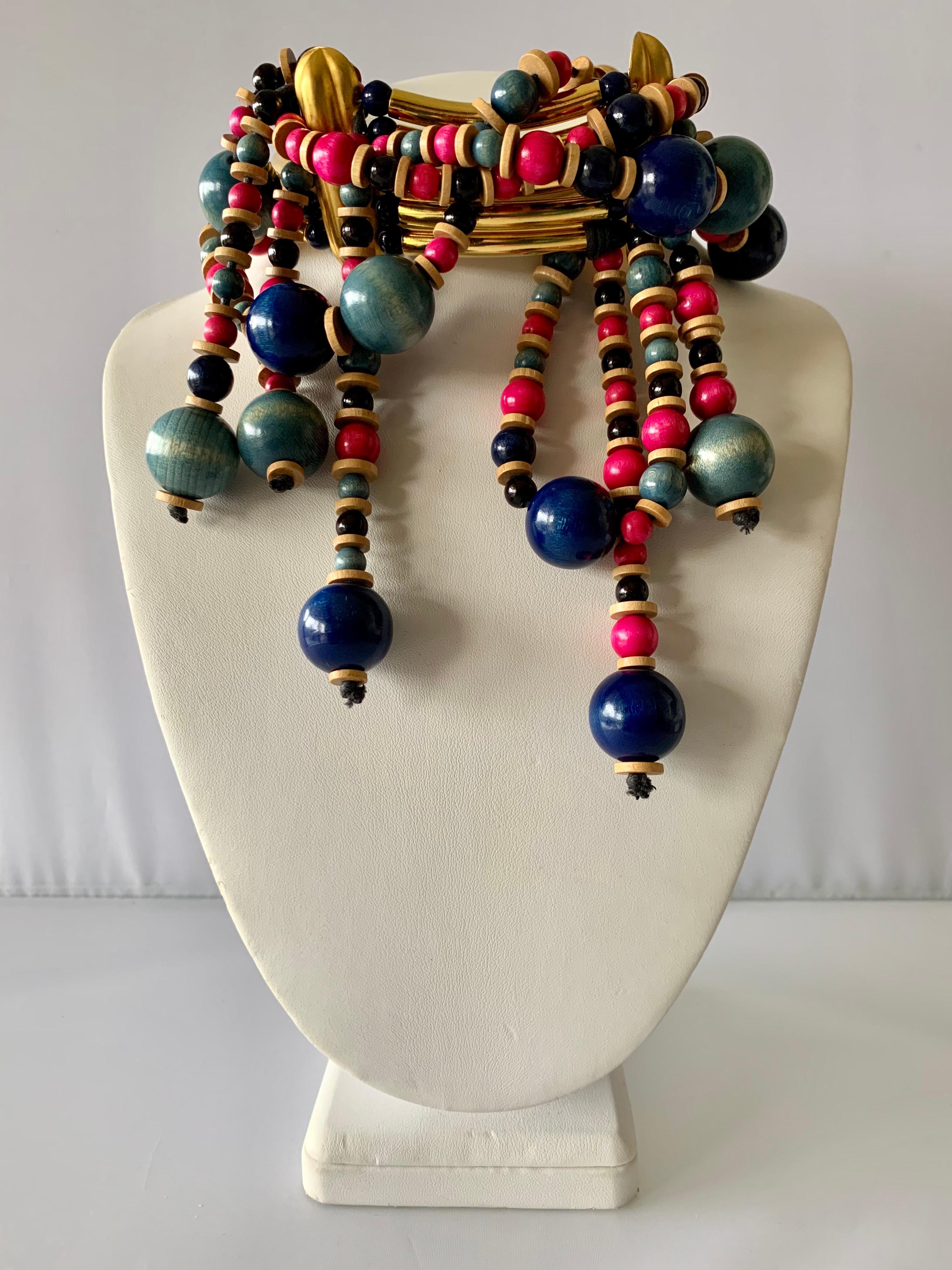 Exquisite and rare find! Vintage Yves Saint Laurent Haute Couture tribal statement necklace/choker, comprised out of long architectural gilt metal tube beads and round wooden beads in; blue, pink, and turquoise. The beads wrap around the entire