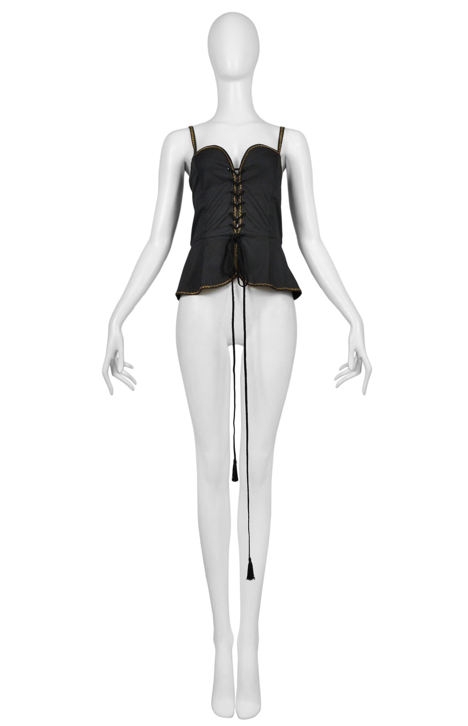 Vintage Yves Saint Laurent black cotton corset top featuring a built-in peplum, gold rickrack trim along the edges and spaghetti straps, and tassel cording lacing at front. Circa 1977.

Excellent Vintage Condition.

Size 38