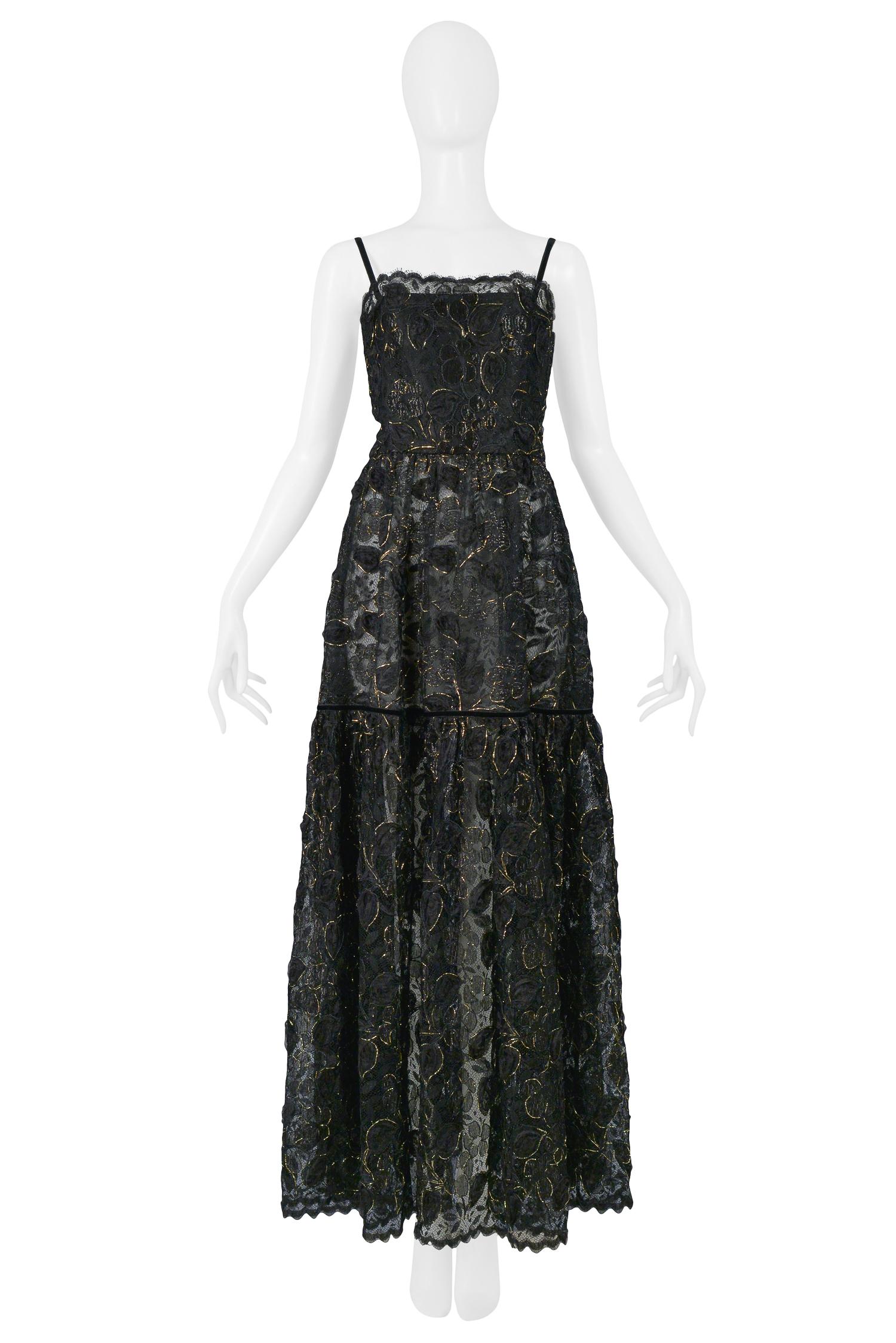 A stunning vintage Yves Saint Laurent black lace evening gown featuring gold thread throughout, a scalloped neck & hem, delicate velvet straps and ribbon at skirt. 

Excellent Condition.

Size: 38