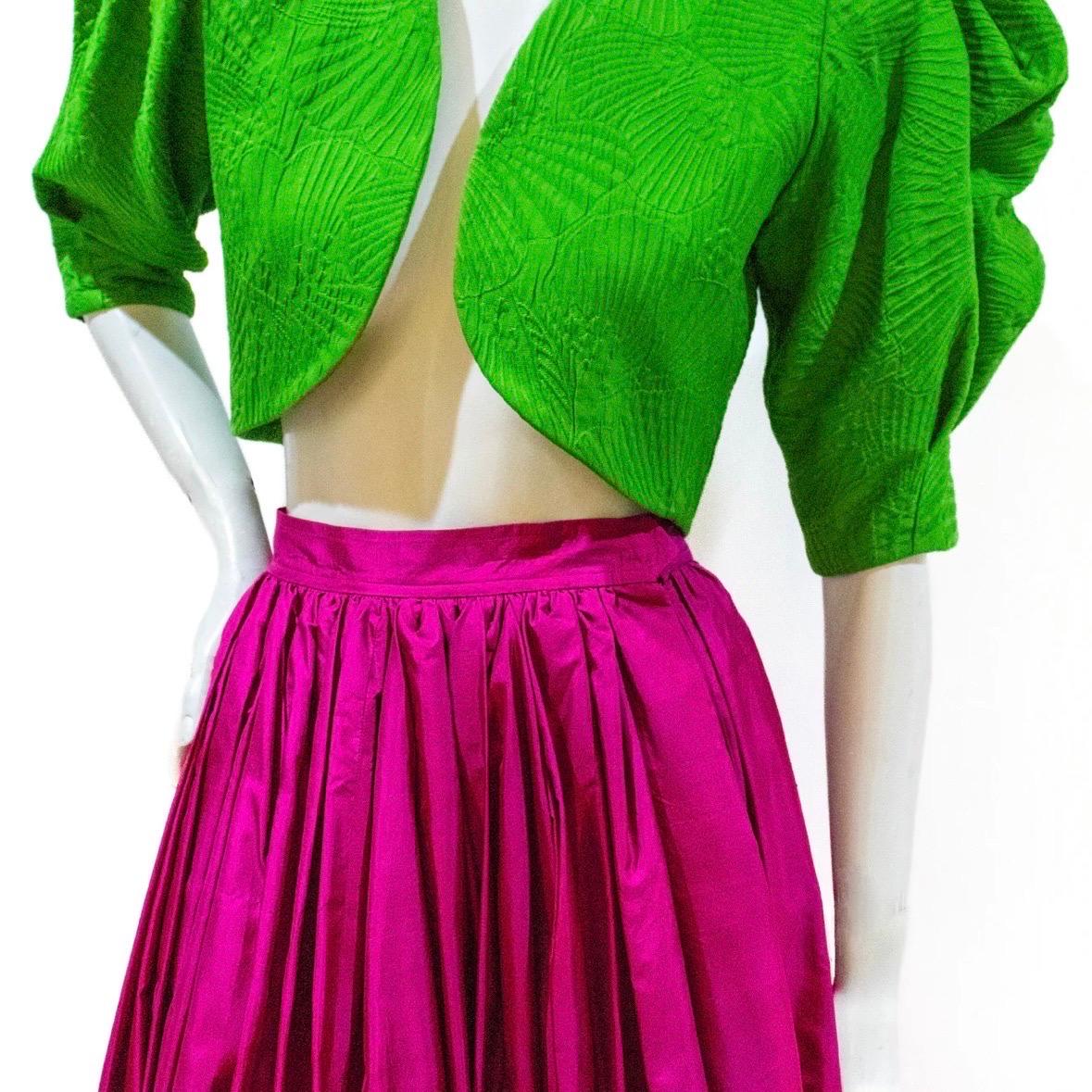 3-piece set with bolero jacket, full skirt, and sash by Yves Saint Laurent (Rive Gauche)

Top Details:
Spring 1975
Made in France
Solid kelly green
Textured floral pattern
Ruffled neck 
Leg of mutton sleeves
Curved hem
Cropped silhouette
Wool