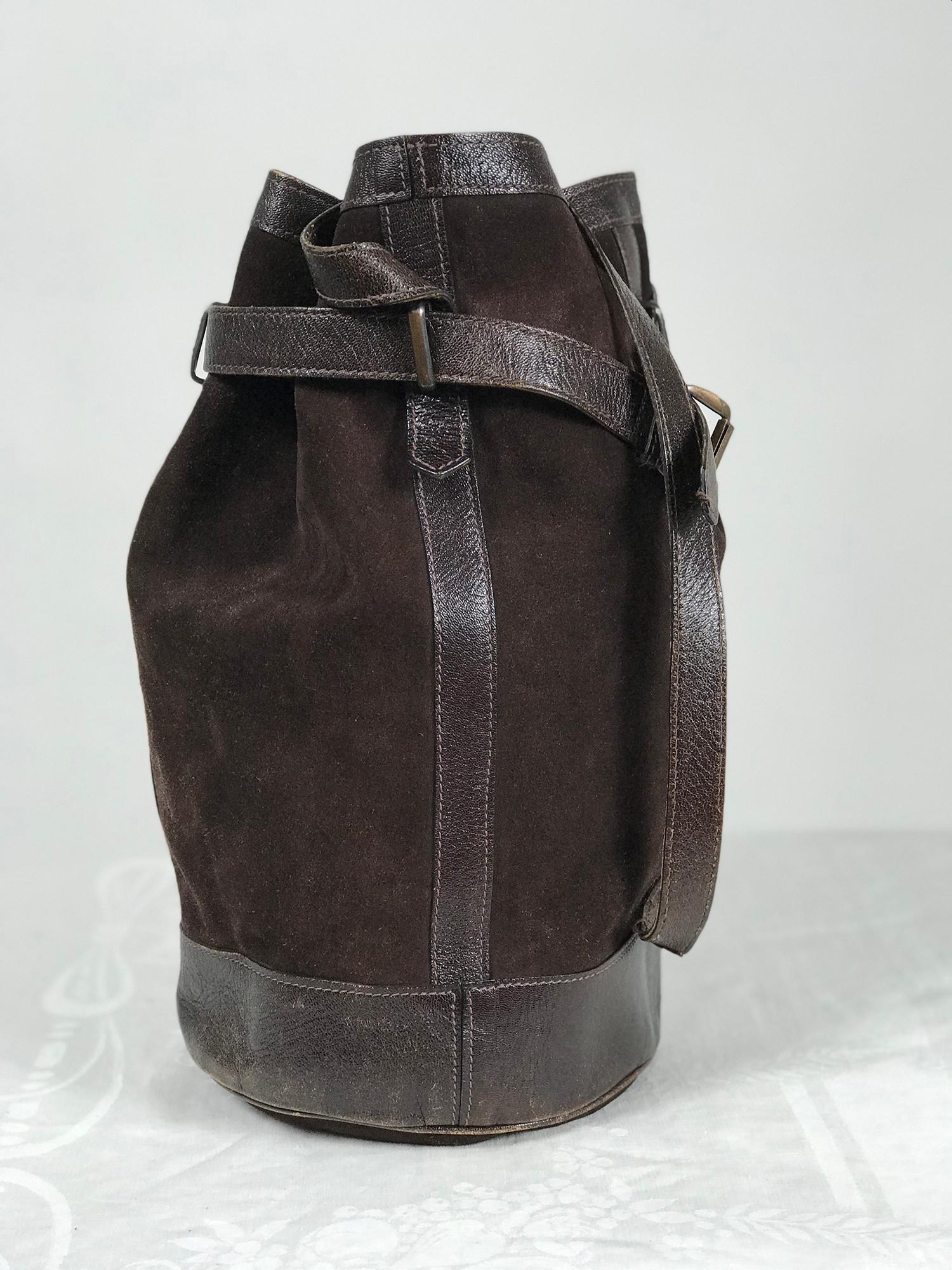 Vintage Yves Saint Laurent brown suede and leather bucket shoulder bag from the 1970s. A beautiful and unique bag is remarkable condition for it's age. Dark chocolate brown soft suede with leather trims and straps. The bag is tall and round, the
