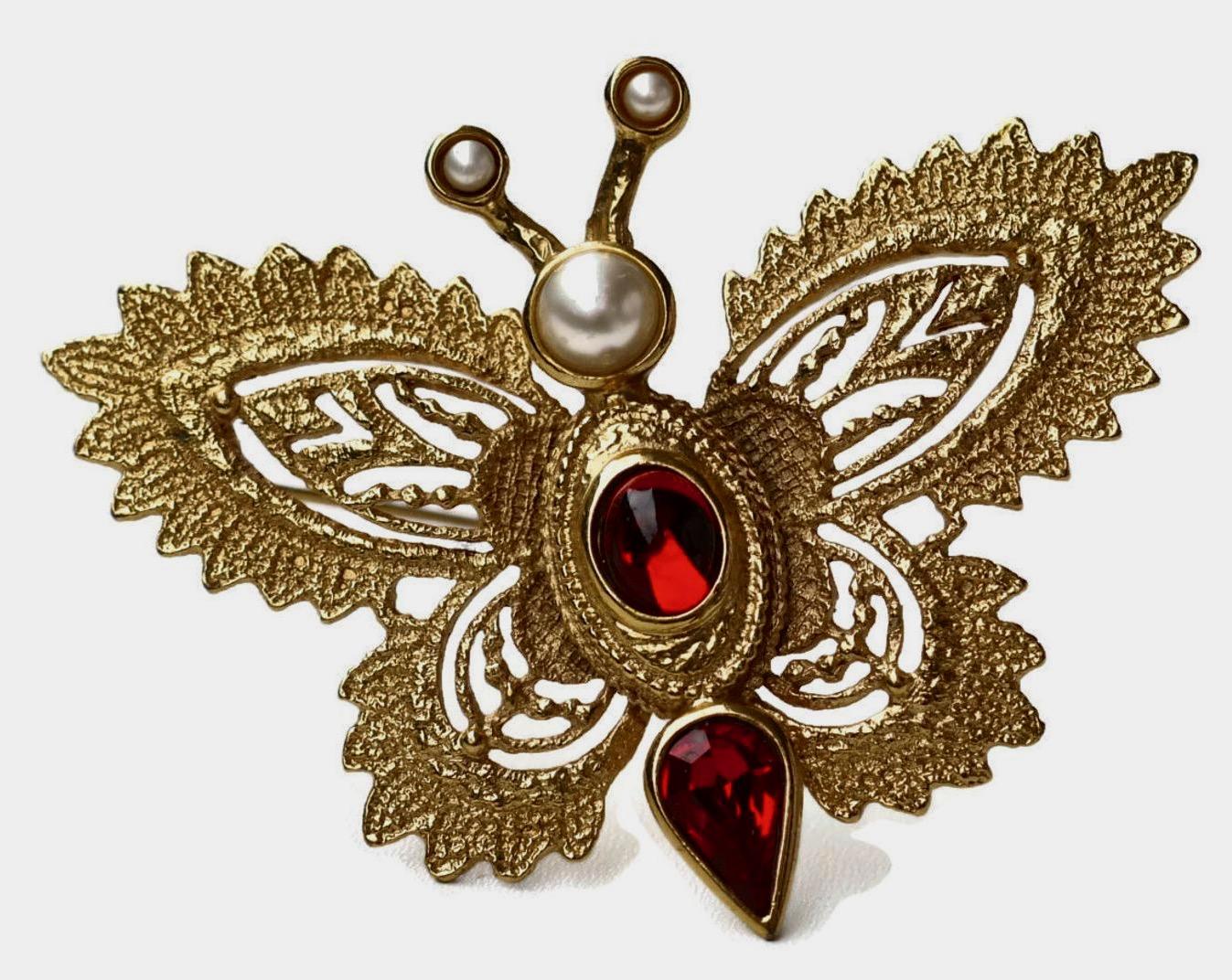 Vintage YVES SAINT LAURENT Butterfly Brooch by Robert Goossens

Measurements:
Height: 6 cms
Width: 8 cms

Features:
- 100% Authentic YVES SAINT LAURENT.
- Intricate gilt metal hardware in gold tone.
- Embellished with Faux Pearls (very minor