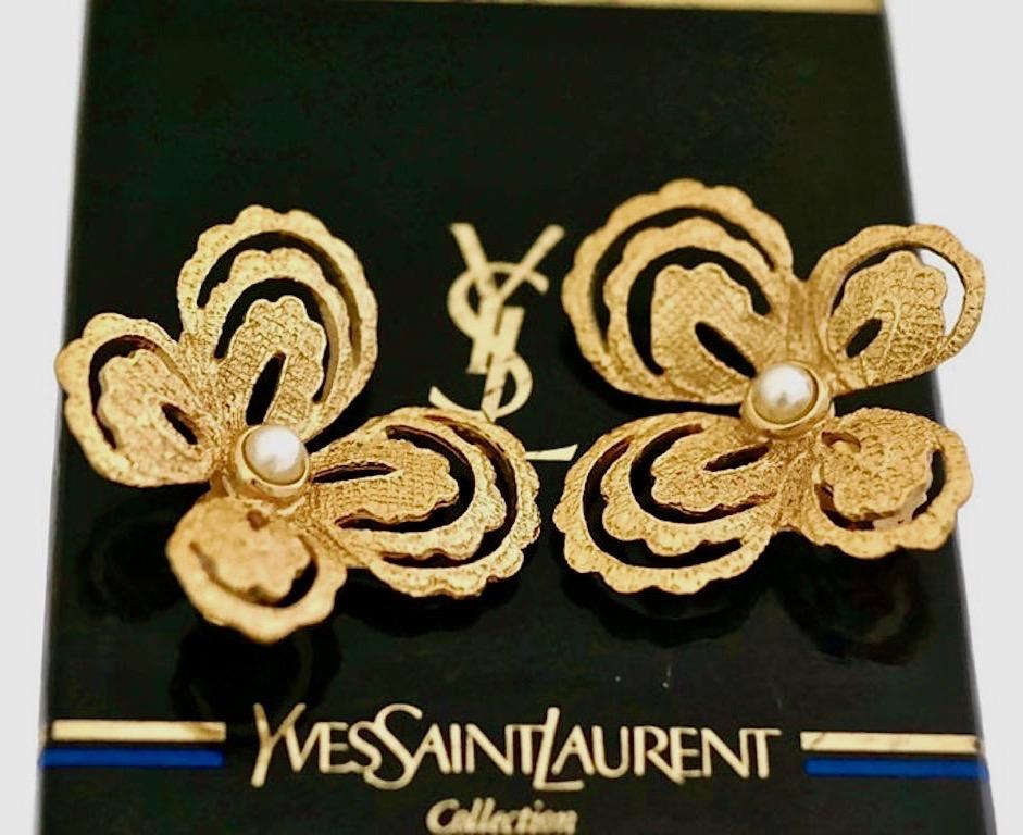Vintage YVES SAINT LAURENT Butterfly Earrings by Robert Goossens

Measurements:
Height: 1 5/8 inches
Width: 1 6/8 inches

Features:
- 100% Authentic YVES SAINT LAURENT.
- Intricate gilt metal hardware in gold tone.
- Embellished with faux pearls.
-