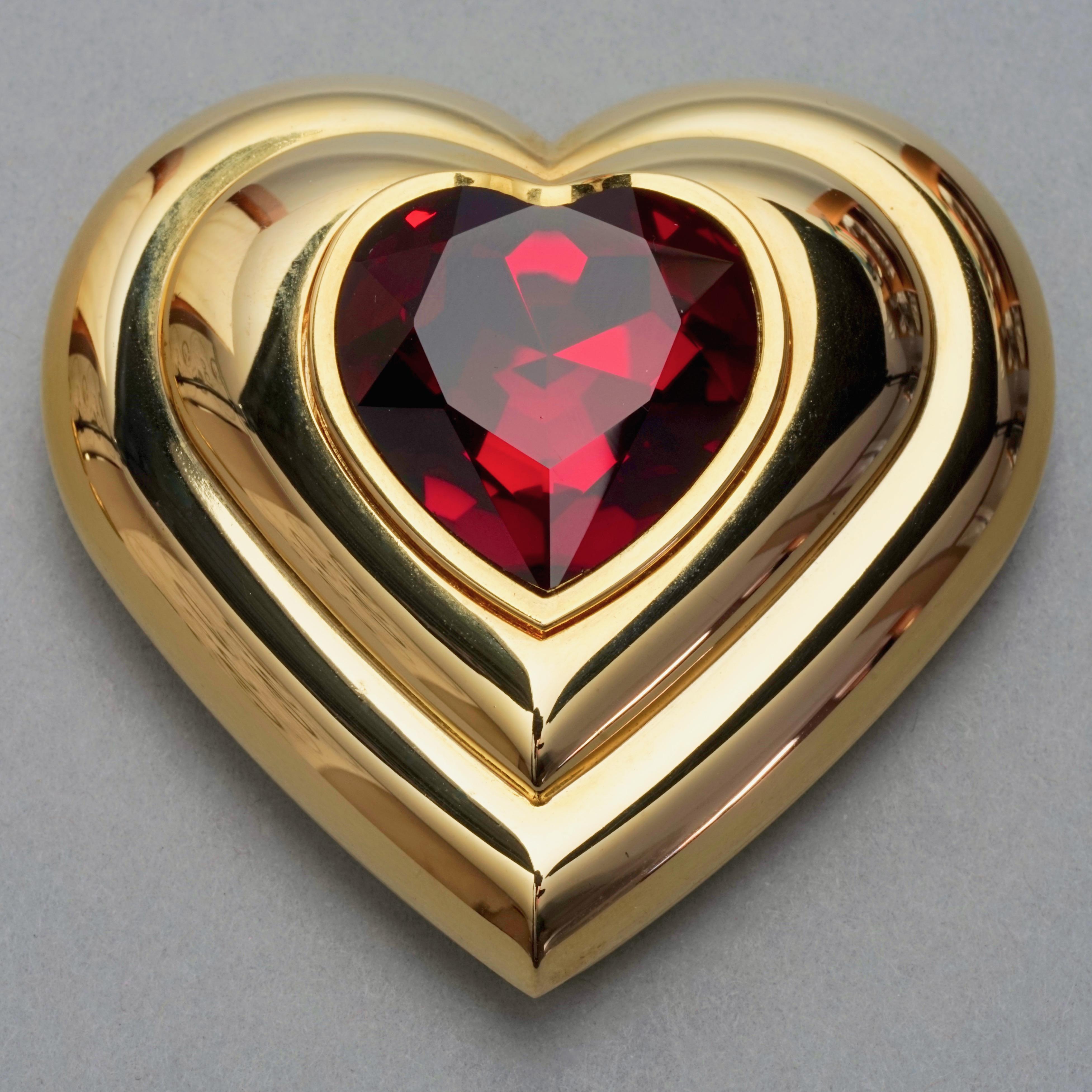 Vintage YVES SAINT LAURENT by Robert Goossens Red Heart Jewelled Compact Powder

Measurements:
Height: 2.63 inches (6.7 cm)
Width: 2.63 inches (6.7 cm)

Features:
- 100% Authentic YVES SAINT LAURENT by Robert Goossens.
- Heart red rhinestone