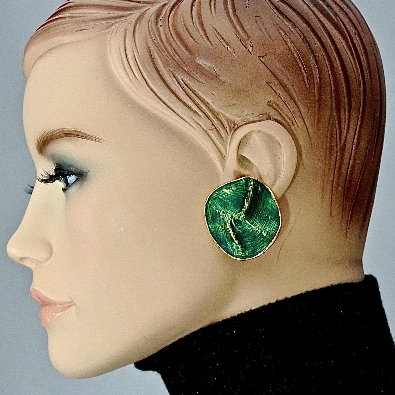 Vintage YVES SAINT LAURENT by Robert Goossens Wrinkled Enamel Disc Earrings

Measurements:
Height: 1.45 inches (3.7 cm)
Width: 1.45 inches (3.7 cm)
Weight per Earring: 13 grams

Features:
- 100% Authentic YVES SAINT LAURENT by Robert Goossens .
-