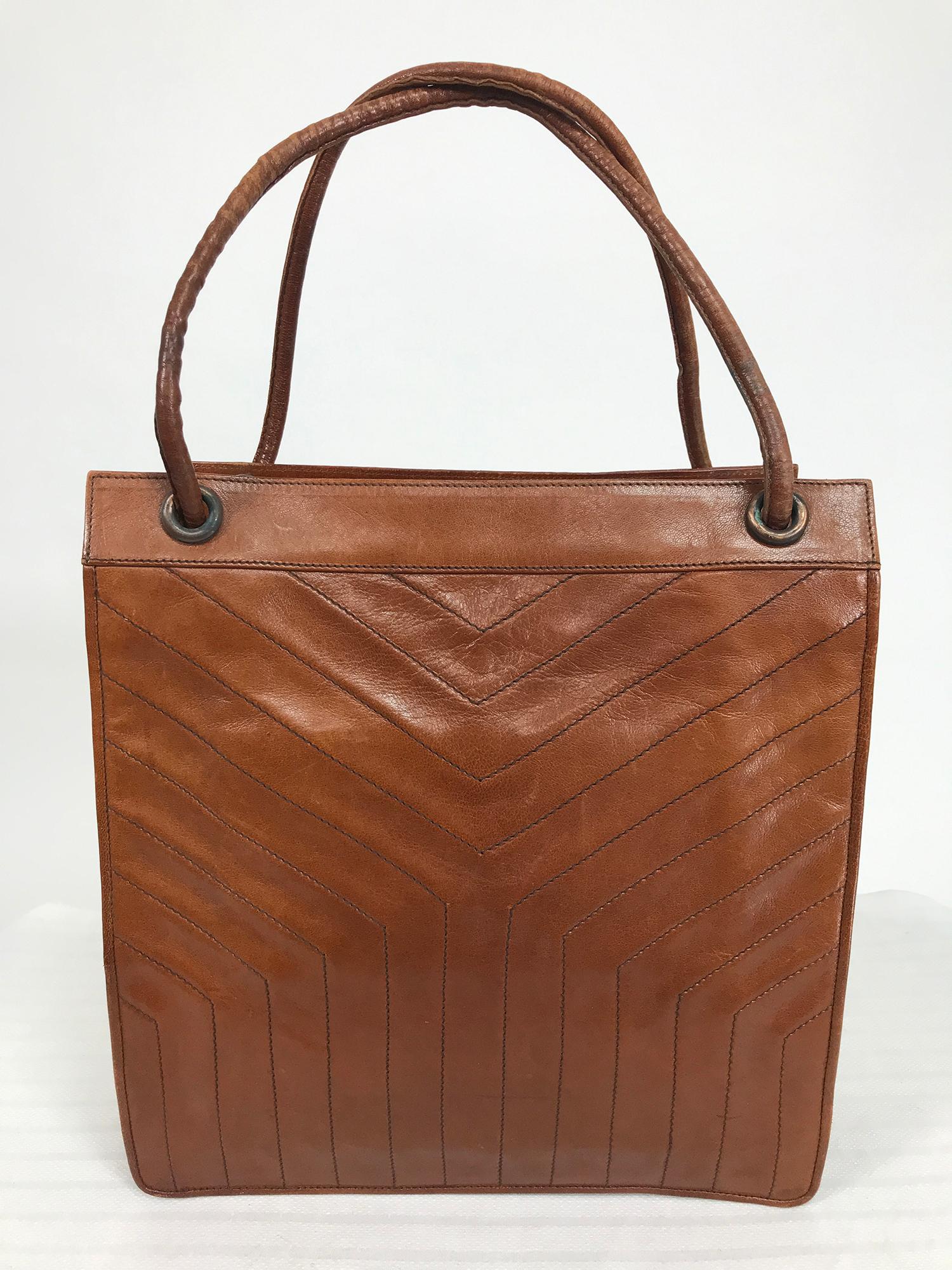 Vintage Yves Saint Laurent caramel leather hand/tote bag from the 1970s. Hand or tote bag in soft glazed caramel colour leather, the front and back are a stitched quilted design, the round padded handle can be carried as a single strap or a double