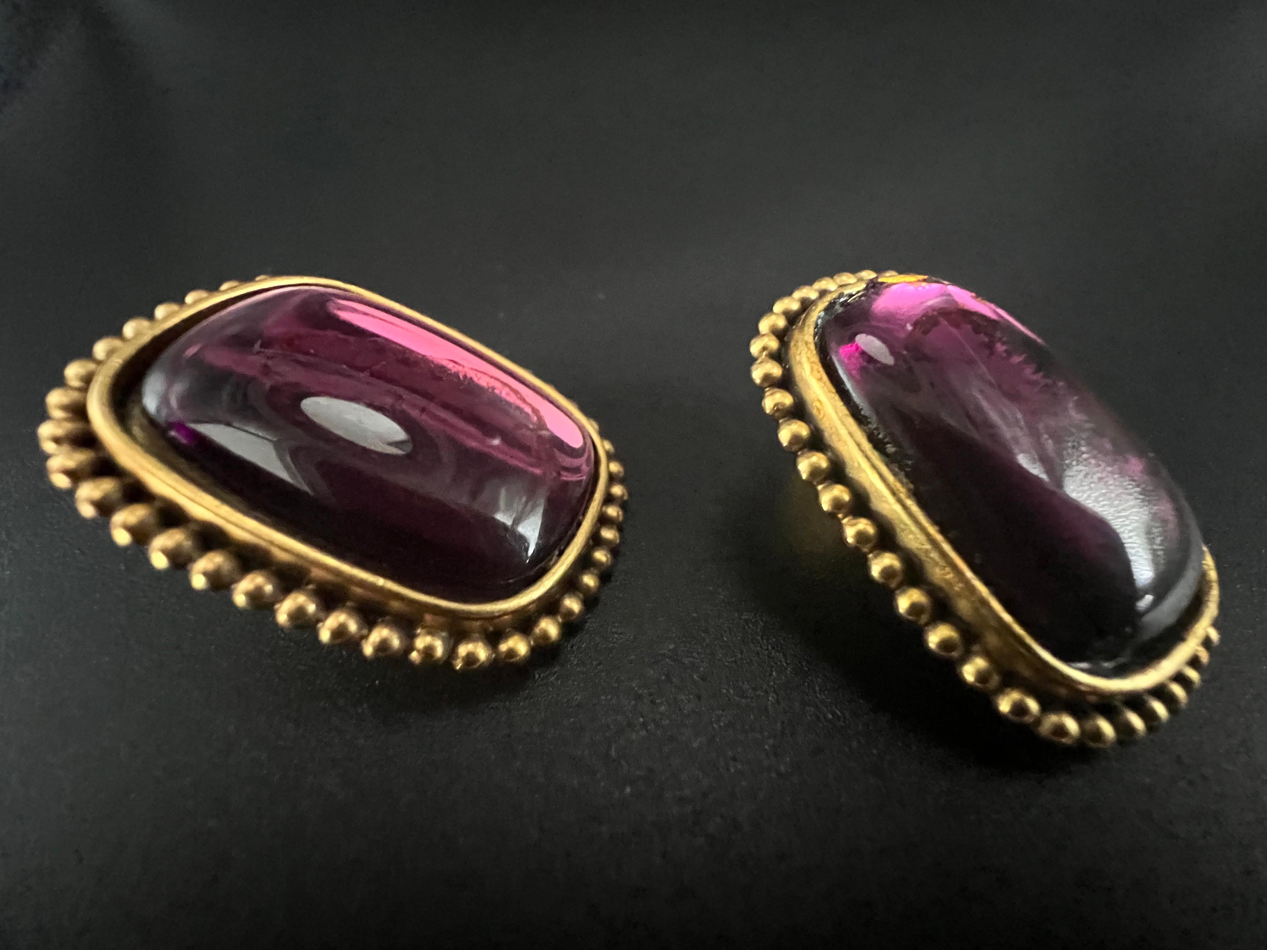   • Designer: Yves Saint Laurent  • Style: Clip-on earrings  • Materials: Gold-tone metal, glass (amethyst hue)  • Size: Approx. 27mmX34mm.
• Signature: Marked YSL on the clip backs  • Era: 1980s to early 1990s vintage
• Origin: Made in France
•