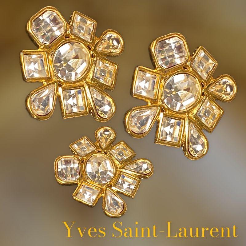 Vintage YVES SAINT LAURENT earrings never worn. There is the choice, to buy earrings alone or the complete set. The buckles with the brooch or the brooch alone, these are rhinestones from Swarovski and the gold metal is always 24-carat plating.
