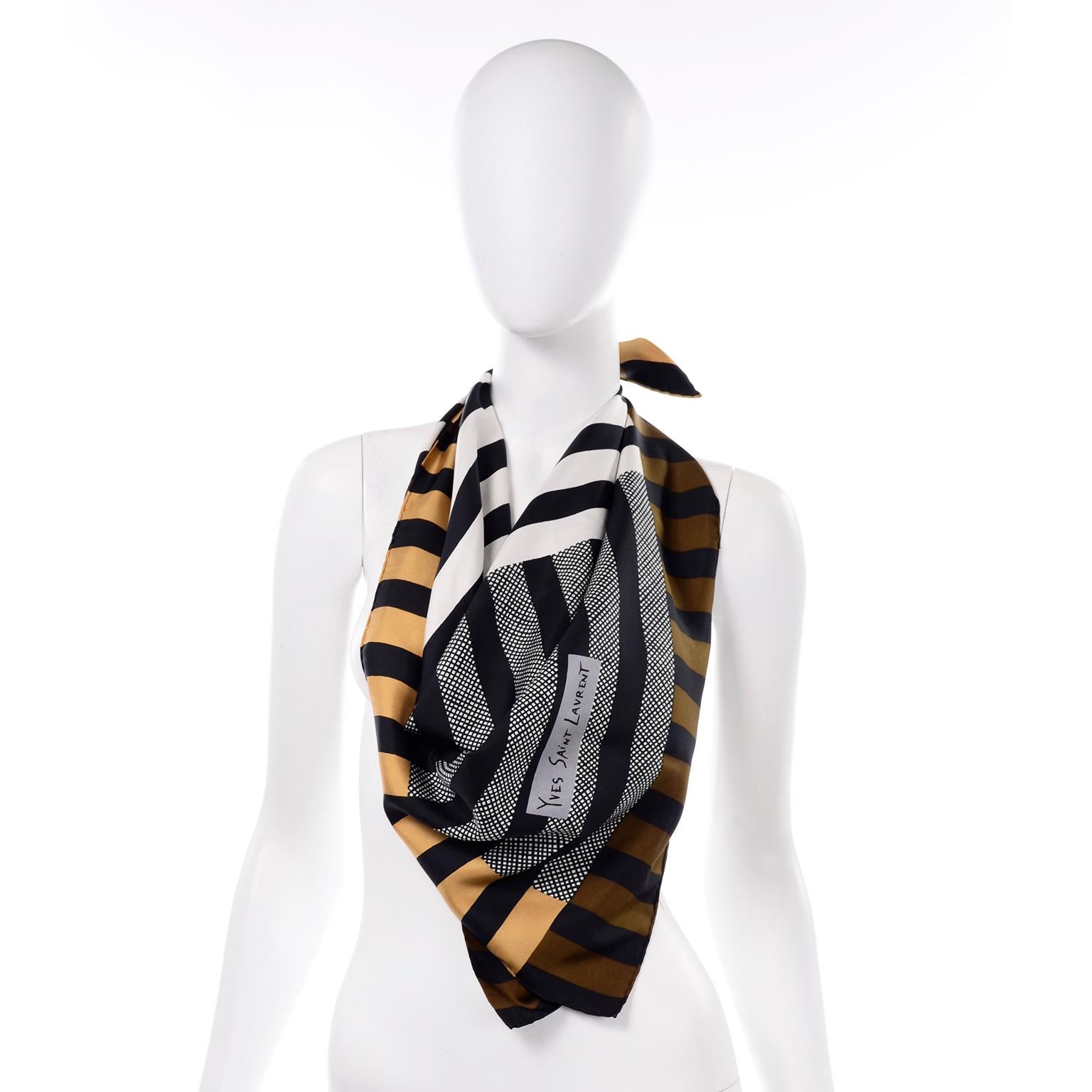 We love Yves Saint Laurent vintage scarves and this one is so modern with its geometric lines running in various directions.  The scarf has hand rolled edges and has the Yves Saint Laurent signature in the print.. No tags or labels. We guarantee