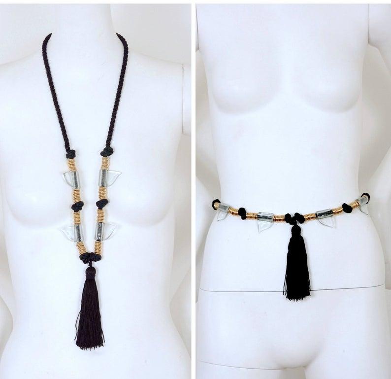 Vintage YVES SAINT LAURENT Glass Shark Tooth Tassel Russian Collection Necklace Belt

Measurements:
Height: 1 3/8 inches
Length: 46 inches
Tassel: 4 6/8 inches

Features:
- 100% Authentic YVES SAINT LAURENT.
- Black woven silk cord.
- Alternate gold