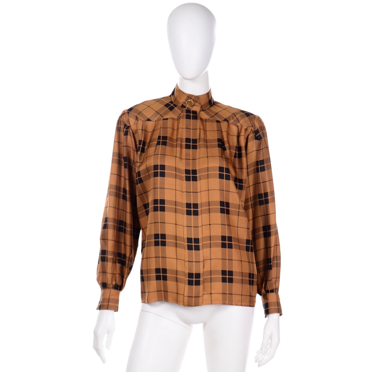 This is a beautiful vintage late 1980's or early 1990's Yves Saint Laurent Rive Gauche copper and black plaid silk blouse. The blouse has a separate sash that can be tied into a knot or bow at the neck.

This lovely blouse has unique gold tone