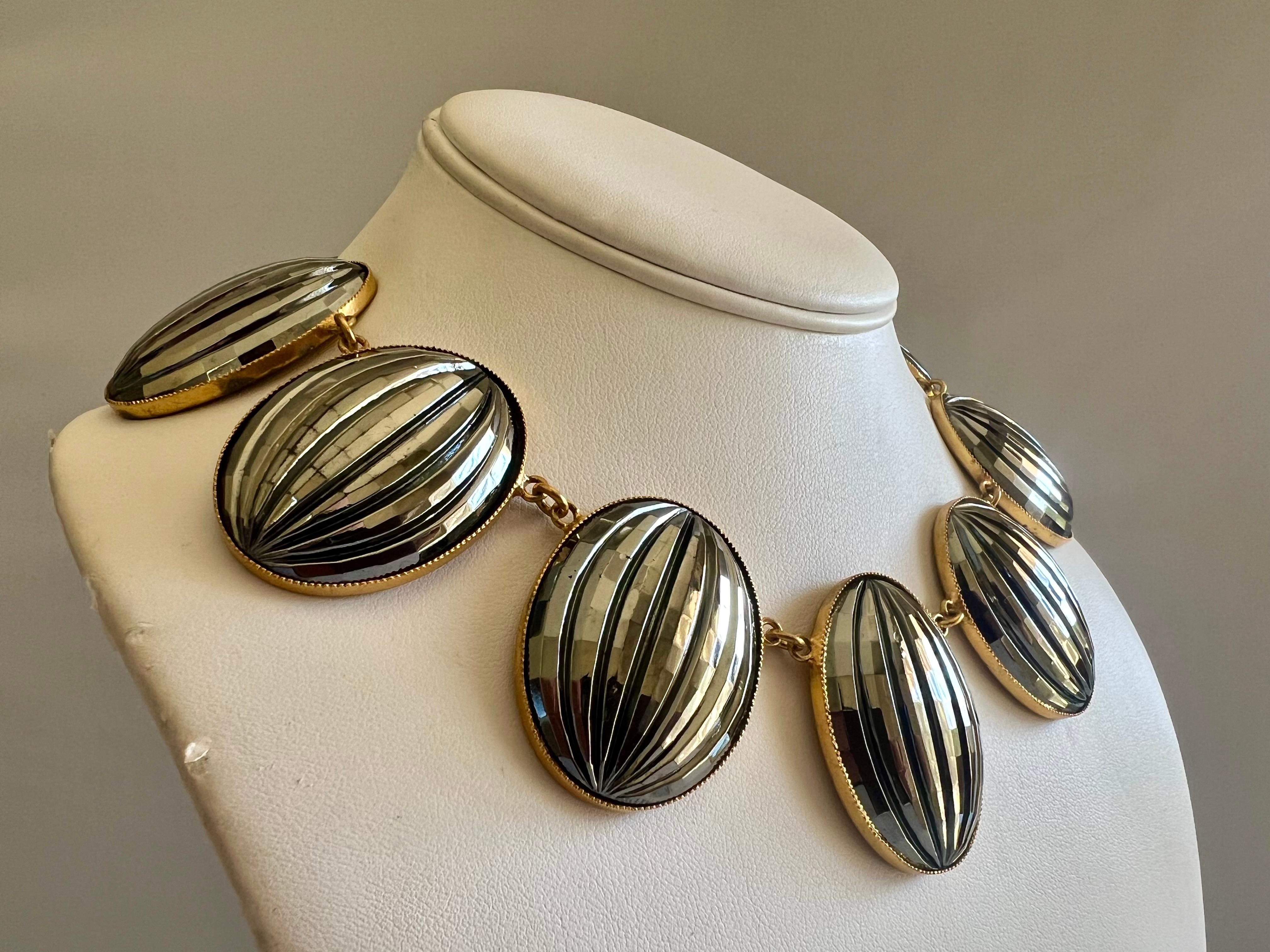 A Vintage Yves Saint Laurent gilt metal necklace with dark grey scalloped glass medallions, circa 1970, came from Madame X, who worked for Mr. Saint Laurent from the 1960s to 1990.