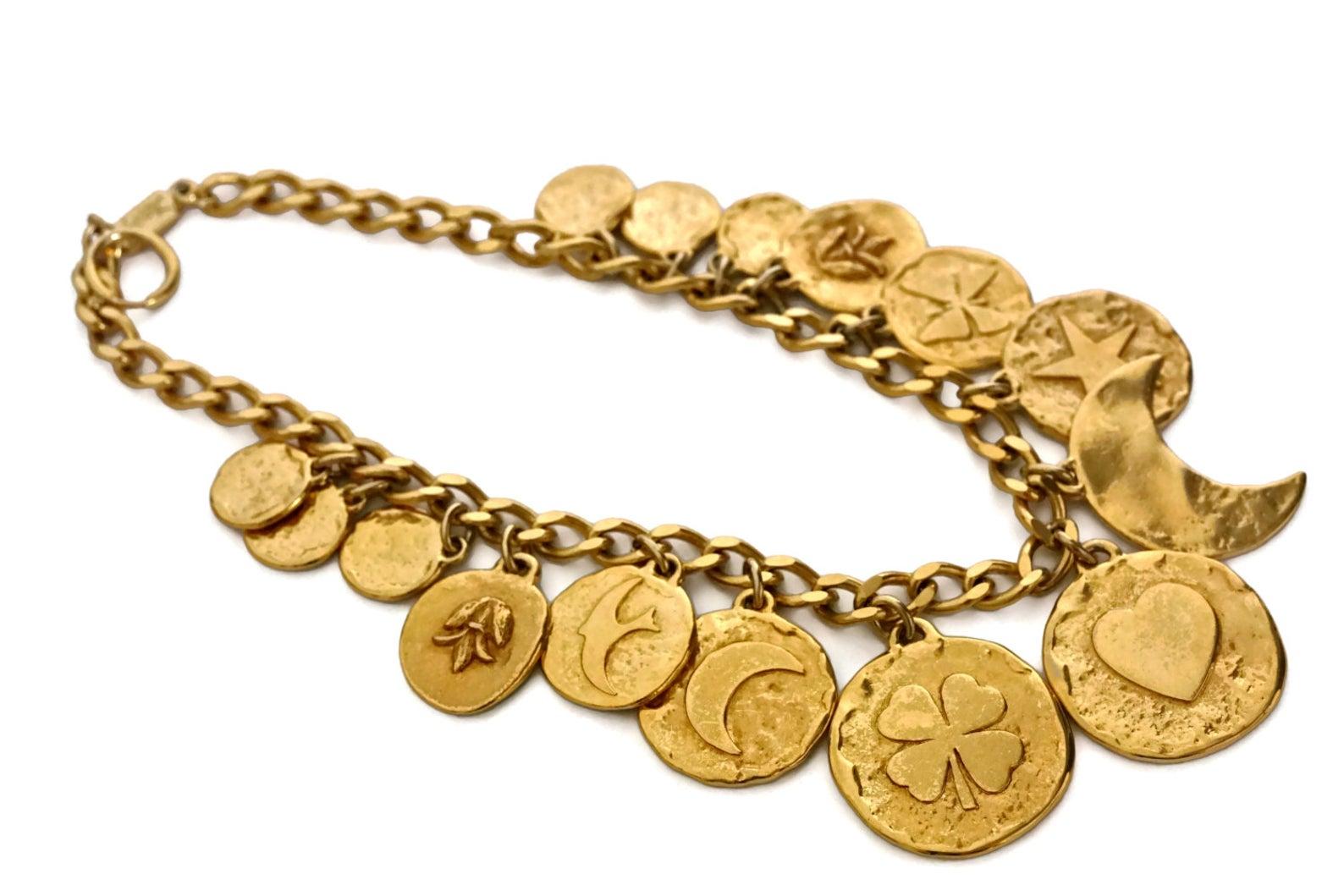 Vintage YVES SAINT LAURENT Iconic Charm Necklace

Measurements:
Height: 2 1/8 inches
Wearable Length: 17 inches (maximum)

Features:
- 100% Authentic YVES SAINT LAURENT.
- Chunky discs with iconic heart, star, moon and clover symbols.
- Adjustable