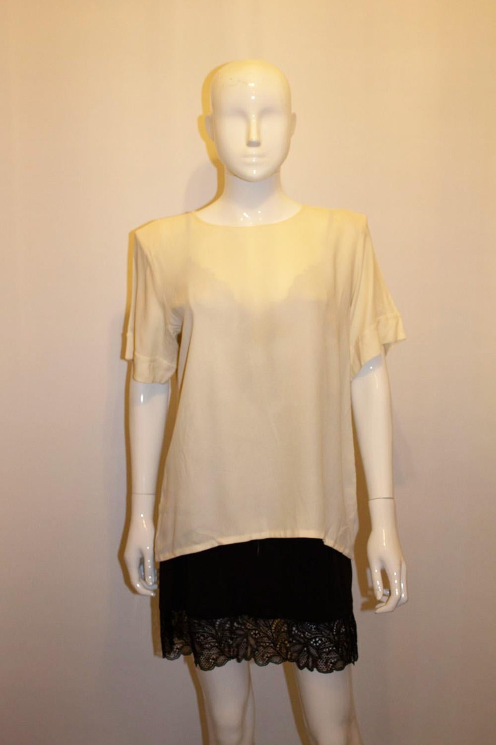 A chic and versatile vintage top by Yves Saint Laurent rive Gauche line. In an ivory colour, the top has a round neckline with detail on the sleaves. 
Size 42 , Measurements Bust up to 42'', length 25''