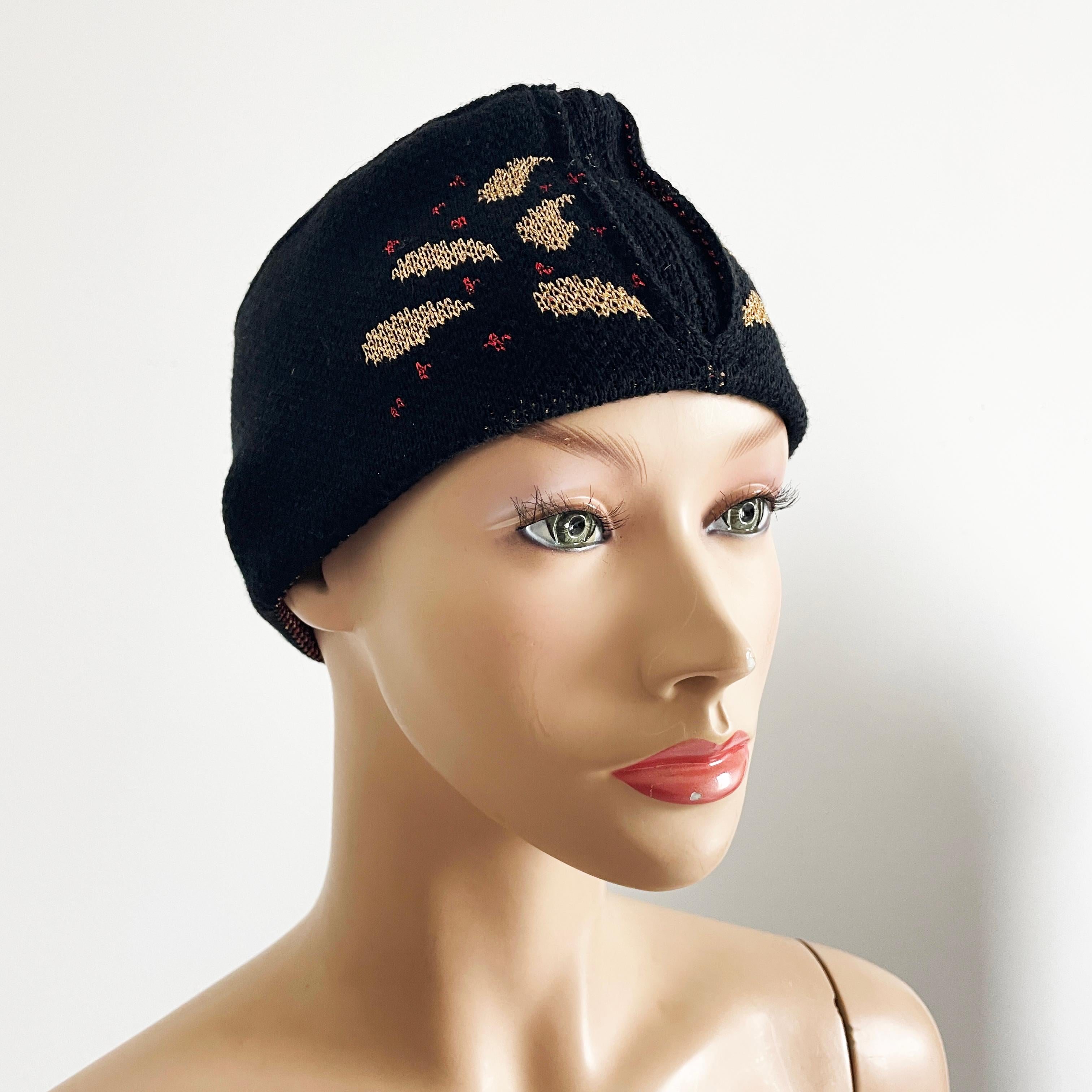 Preowned, vintage knit hat or cap, made by Yves Saint Laurent, most likely in the late 70s or early 80s.  Made from a wool/metallic blend knit, it's shaped Fez-style with an abstract gold and red metallic paisley design.  

A fabulous and
